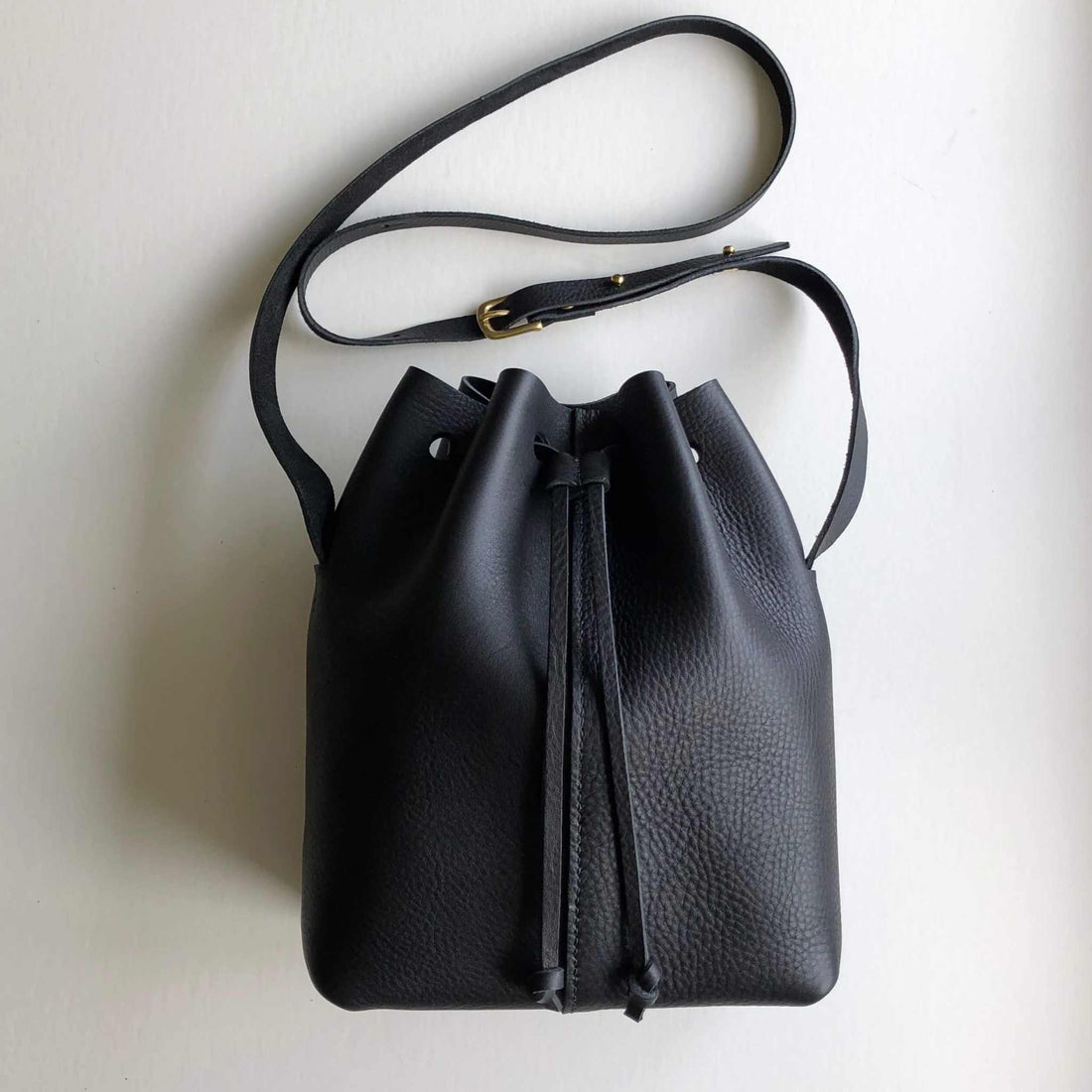 CARV black leather bucket bag in minimalist style with full grain leather