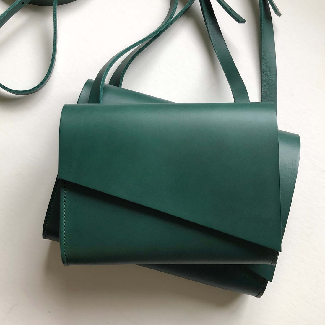 CARV green leather handbag in minimalist style with smooth forest green leather