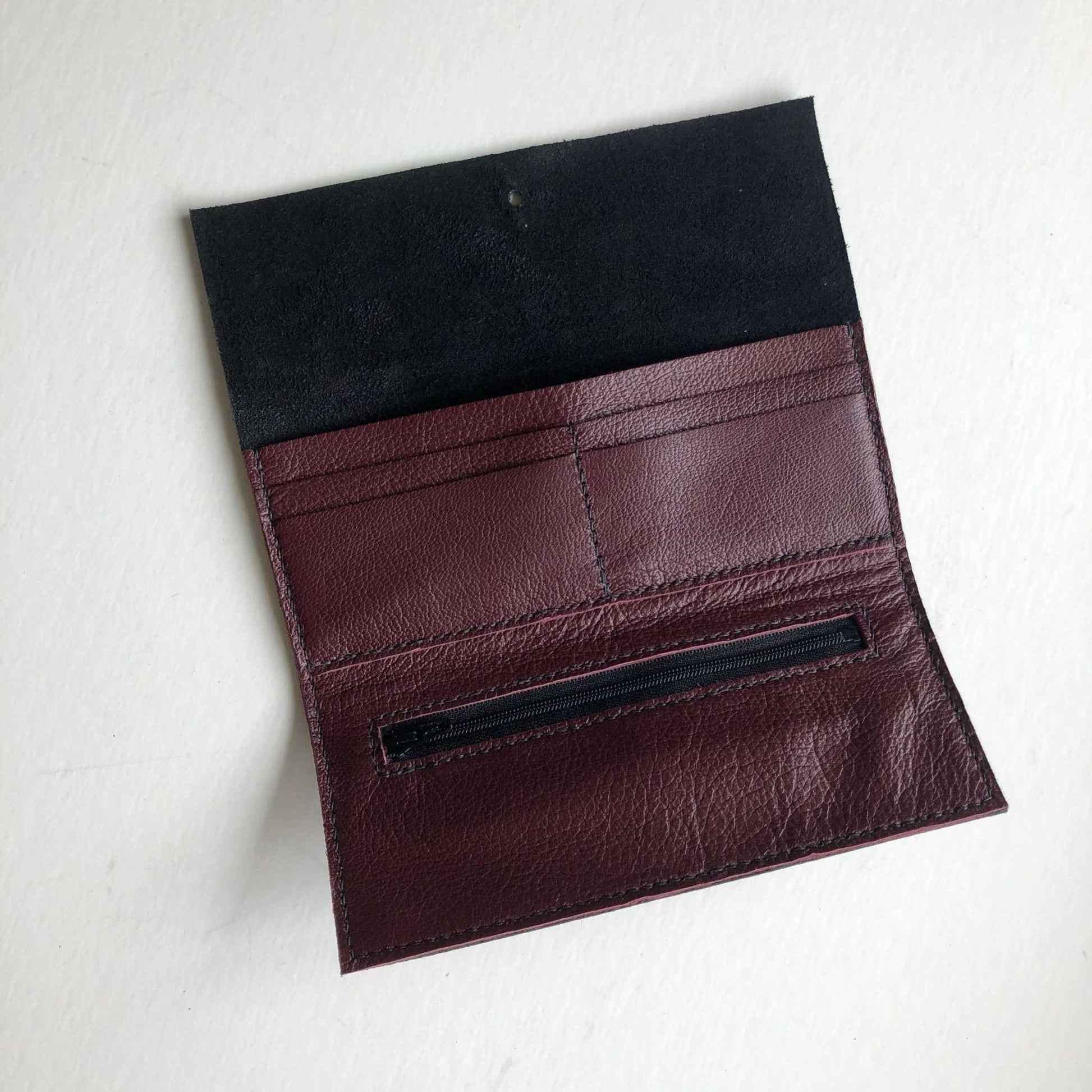 Nomad Midi Leather Folding Wallet in black or tan leather, medium-sized, handcrafted with card slots, zip pocket, and press-stud closure.