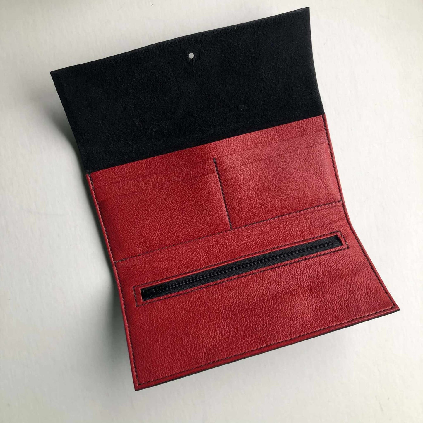 Nomad Maxi Leather Folding Wallet Purse in red and black interior, showcasing card slots and zip pocket, crafted from high-quality leather.