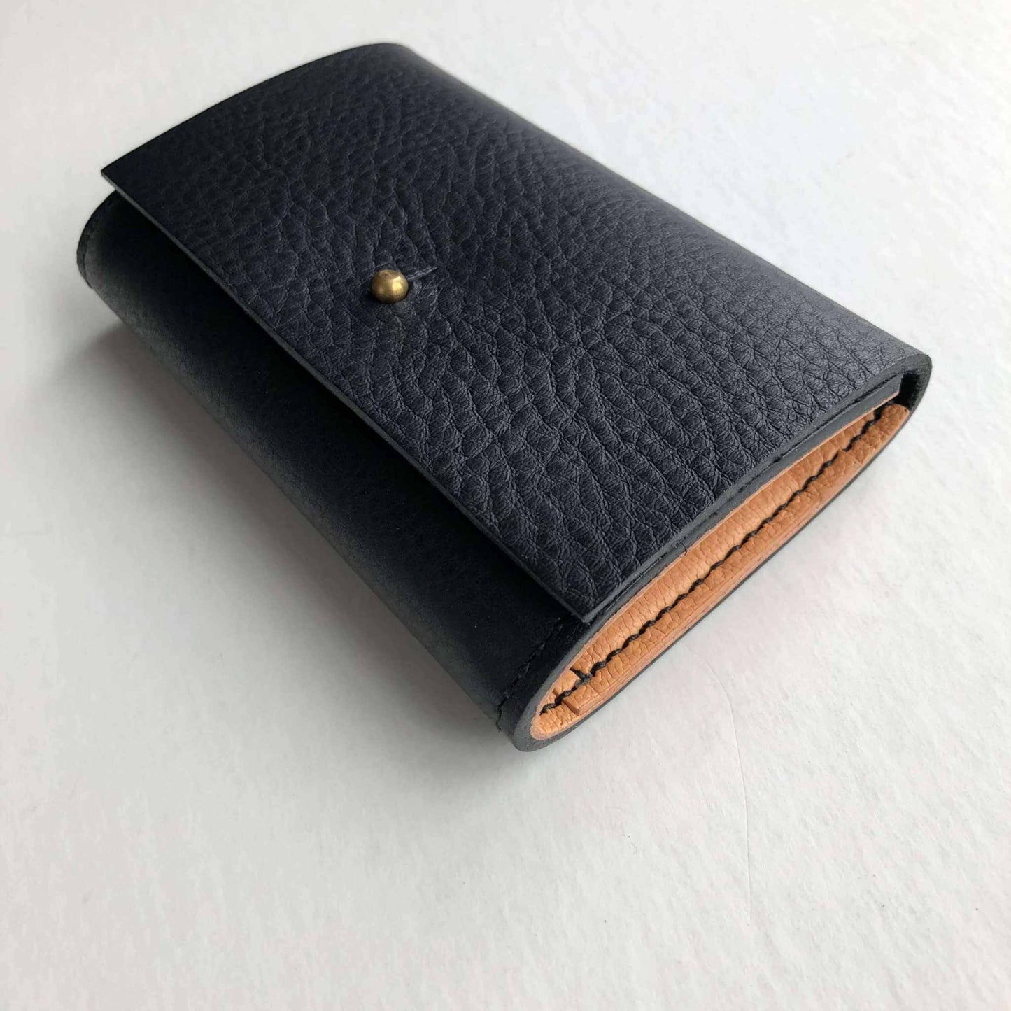 Nomad Mini Handmade Leather Wallet in black, showcasing minimalist luxury and expert craftsmanship.