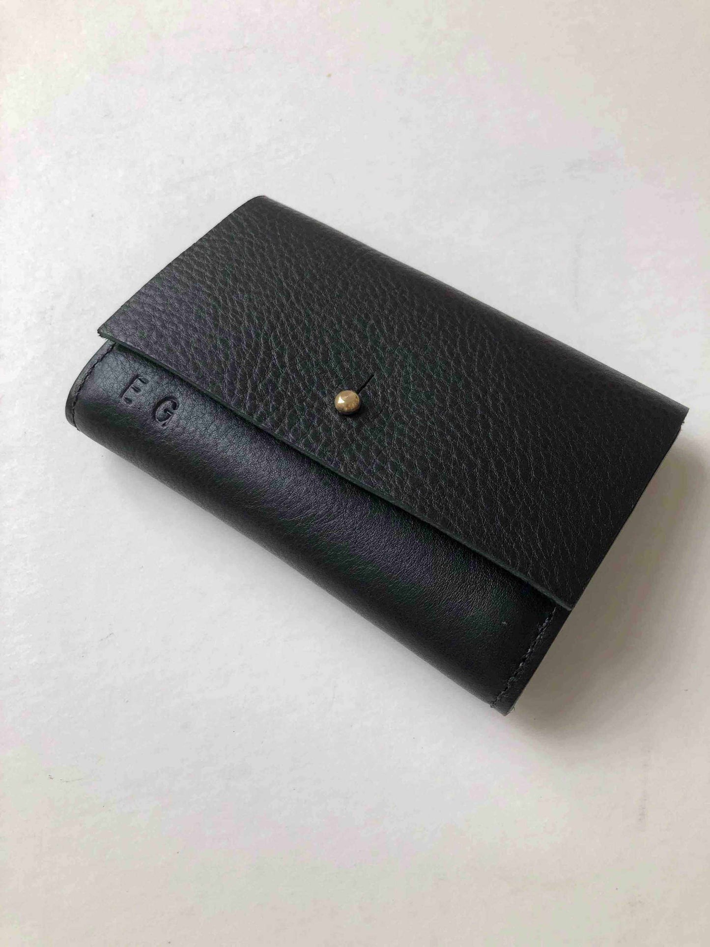 Nomad Mini Handmade Leather Wallet in black with brass press stud clasp.