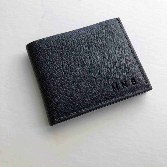 Handmade Black Leather Bifold Wallet crafted in England, featuring sustainable vegetable-tanned leather, minimalist design, and customizable options.