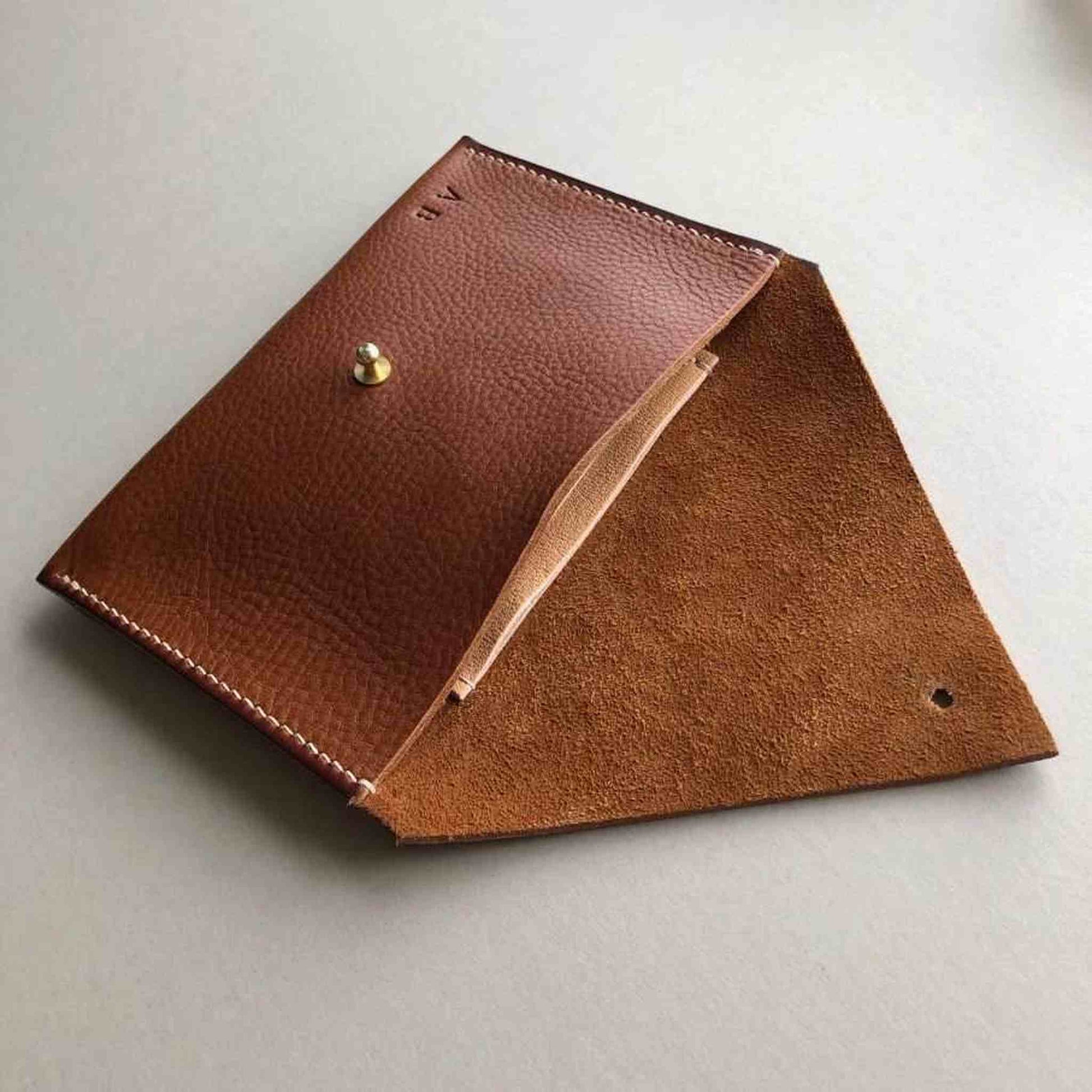 Drifter Maxi Leather Purse Wallet in chestnut tan leather, with triangle flap and brass stud closure, showcasing minimalist British craftsmanship.