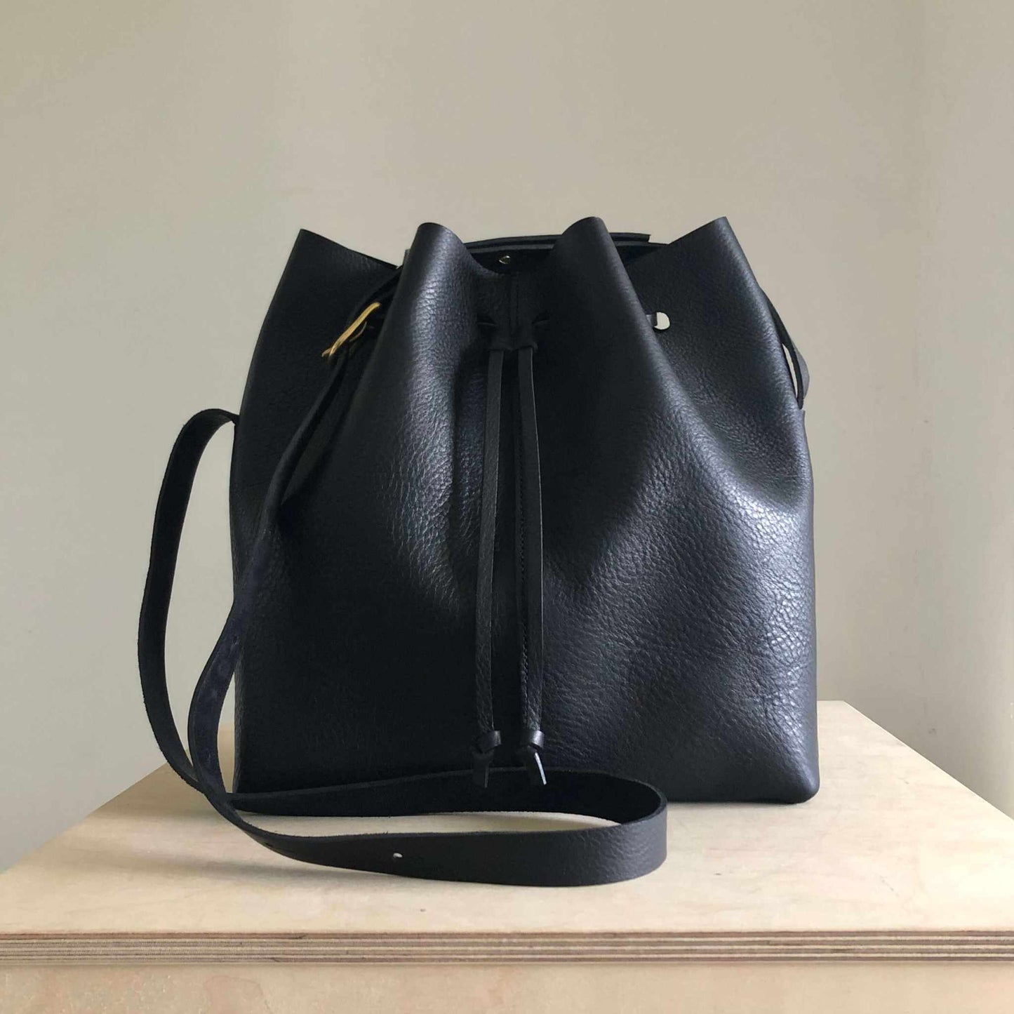 Nomad Maxi Leather Bucket Bag Extra Deep in black, showcasing sophisticated leather texture and minimalist design.