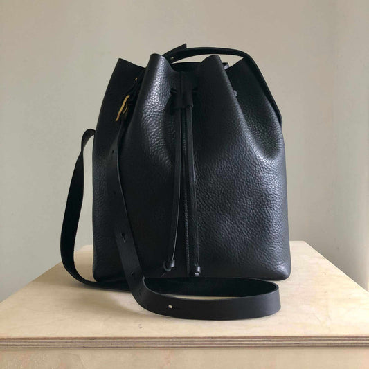 Nomad Maxi Leather Bucket Bag in black with adjustable strap and drawstring closure.