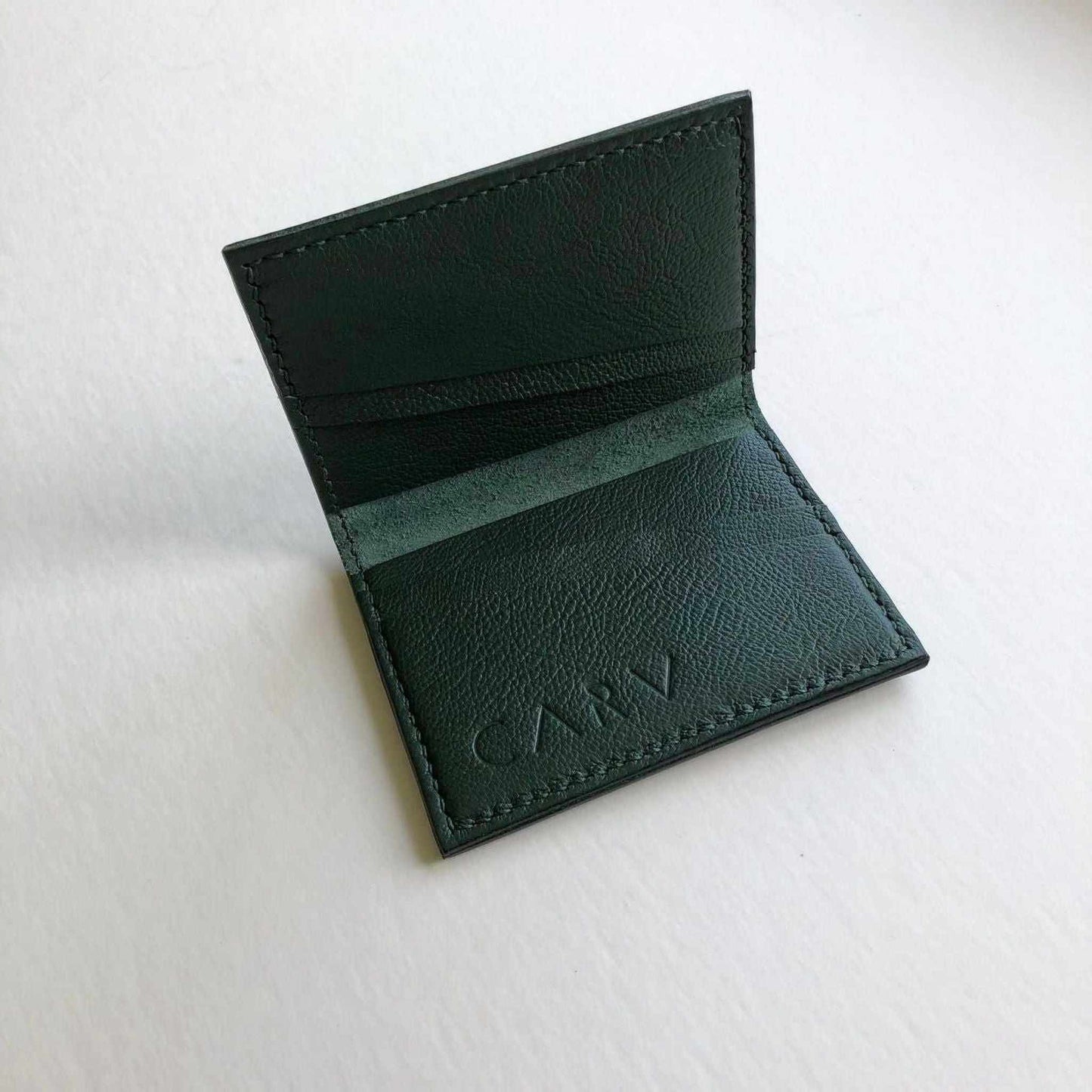 Personalised green leather card wallet by CARV, handcrafted with premium vegetable-tanned leather, featuring four card slots and additional pocket, perfect for modern minimalists and sustainable living.