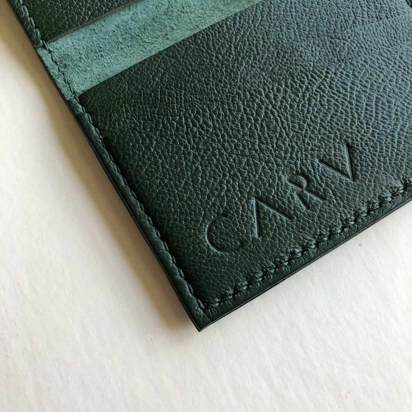 Personalised green leather card wallet with embossed initials, handcrafted with pebble texture by CARV.