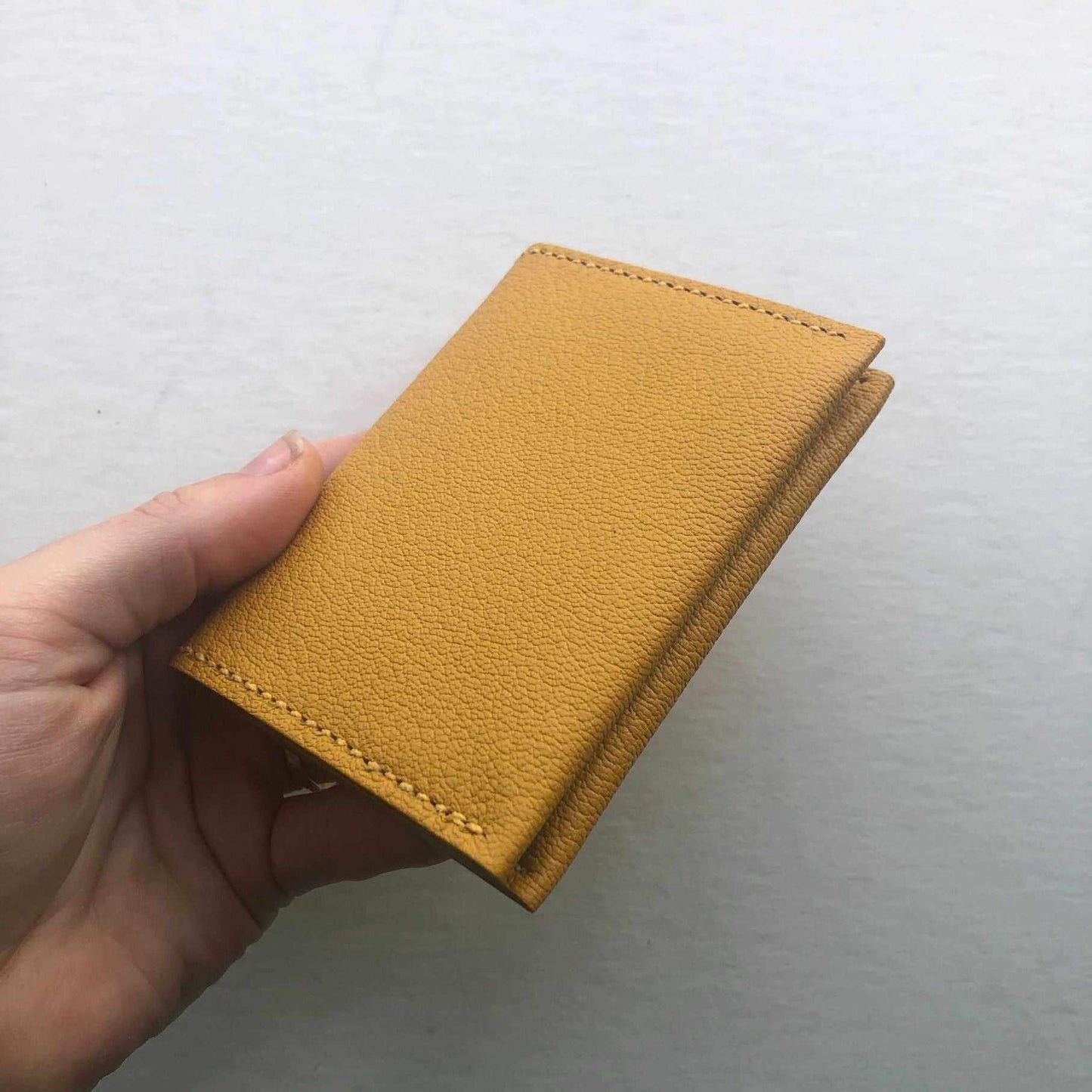 Mustard yellow fold leather bifold card wallet by CARV, handcrafted from sustainable leather.