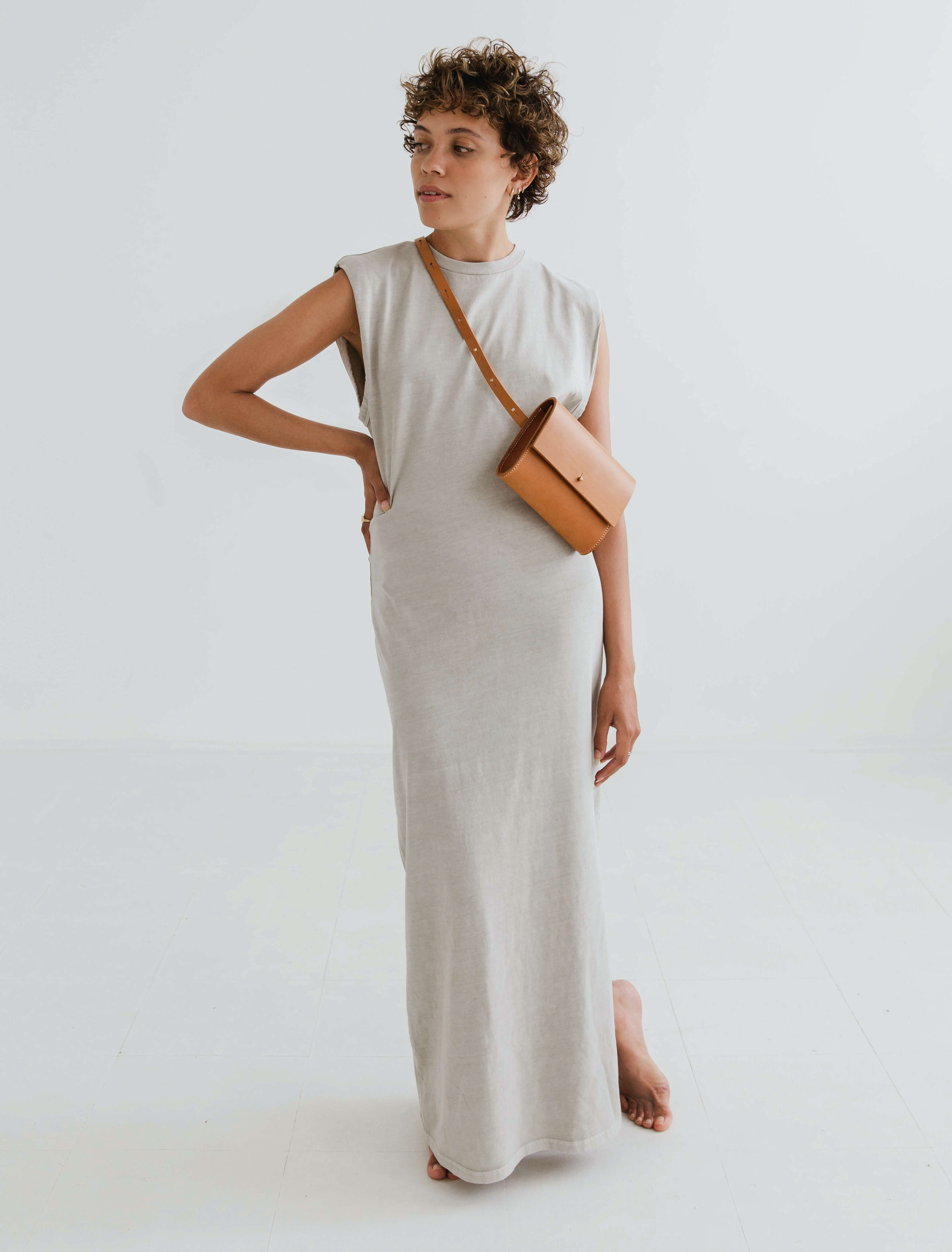 CARV leather belt bag in sand worn on neutral dress