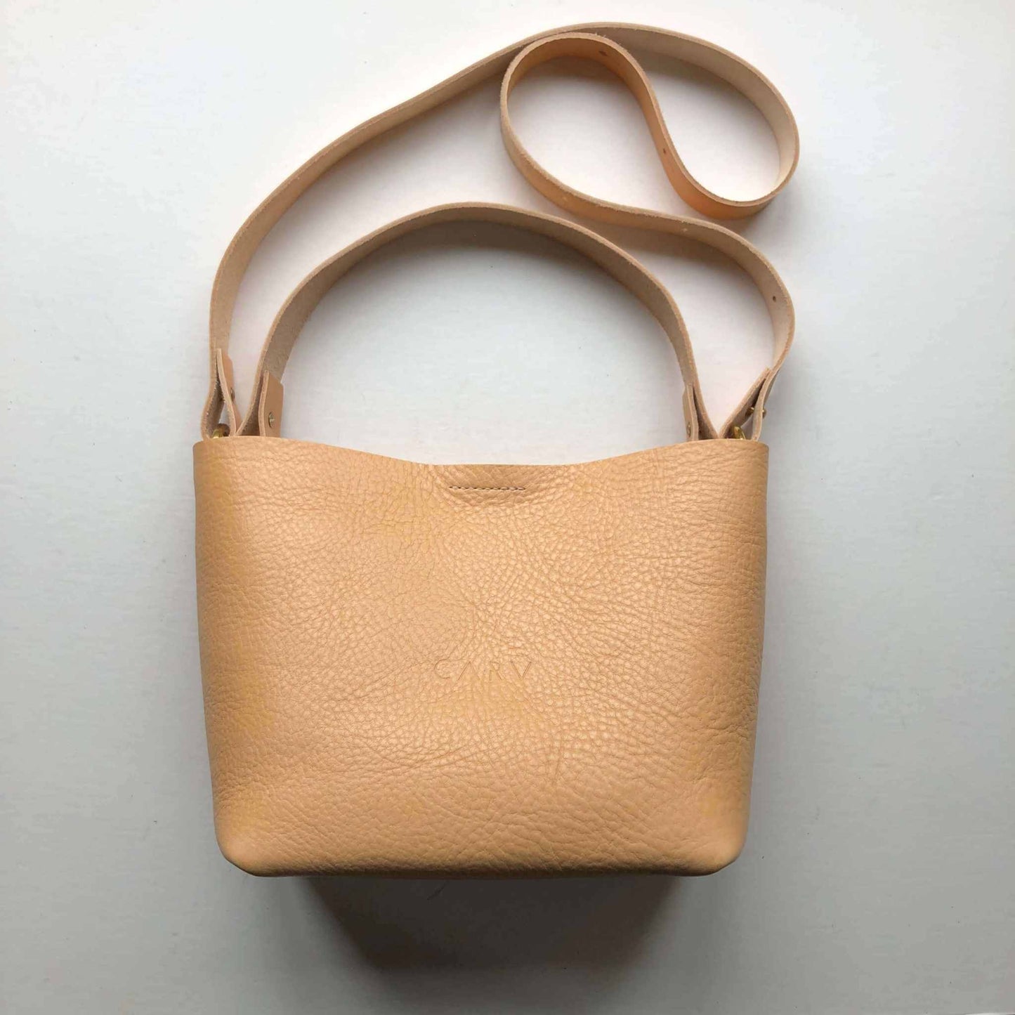 Basket Mini Leather Tote Bag in natural-colored leather with adjustable straps, handcrafted in the UK.