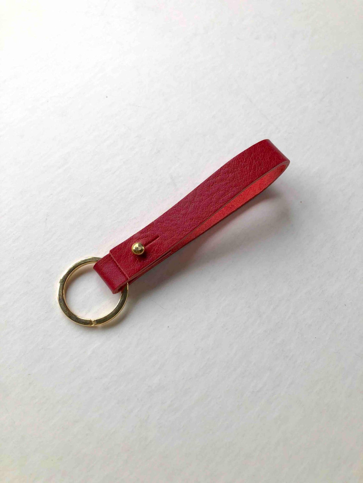 Scarlet red Nomad personalised leather keyring with brass closure.