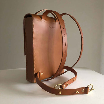 Minimalist Pioneer Tan Leather Backpack with adjustable straps and smooth matte finish.