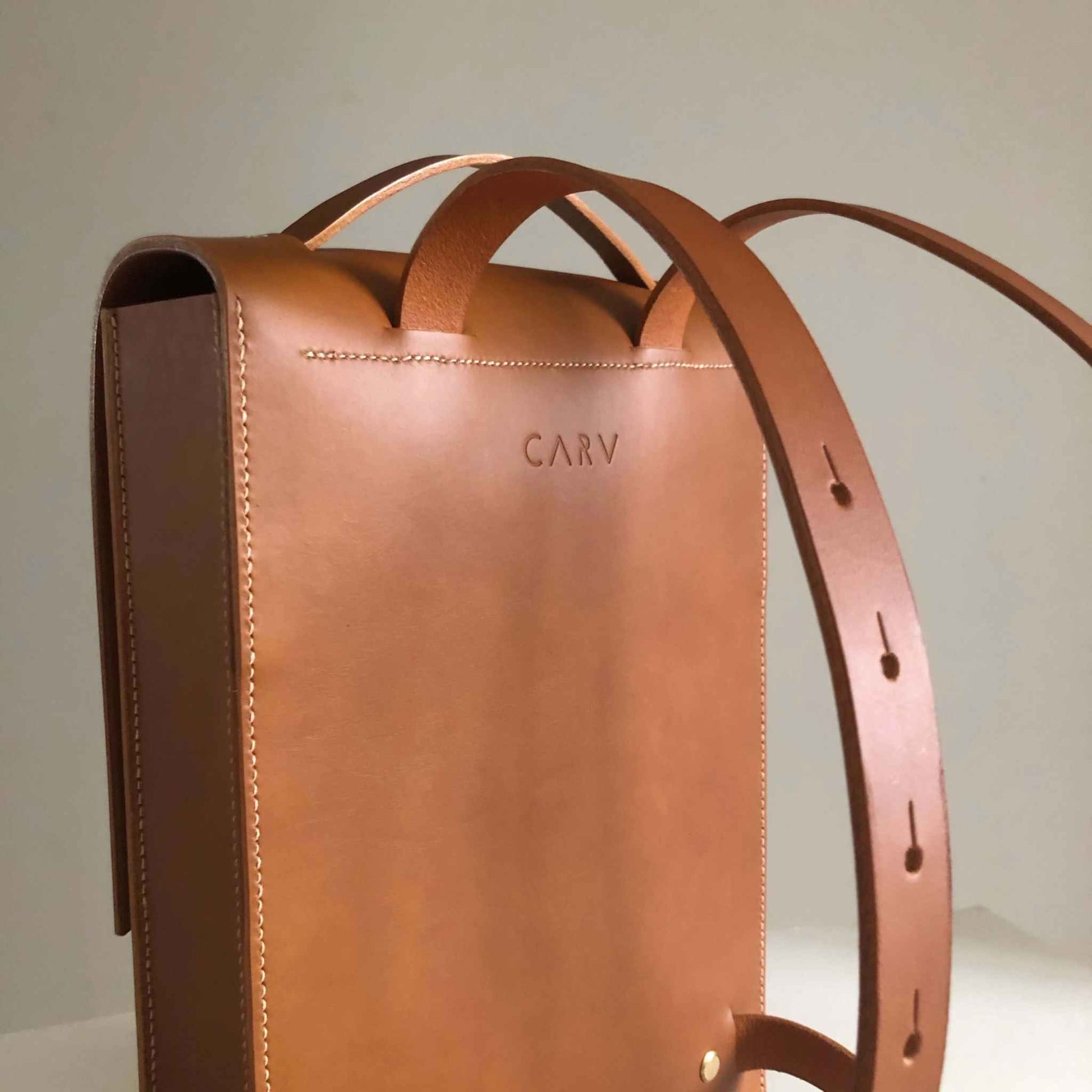 Handcrafted Pioneer Tan Leather Backpack with adjustable straps and minimalist design.