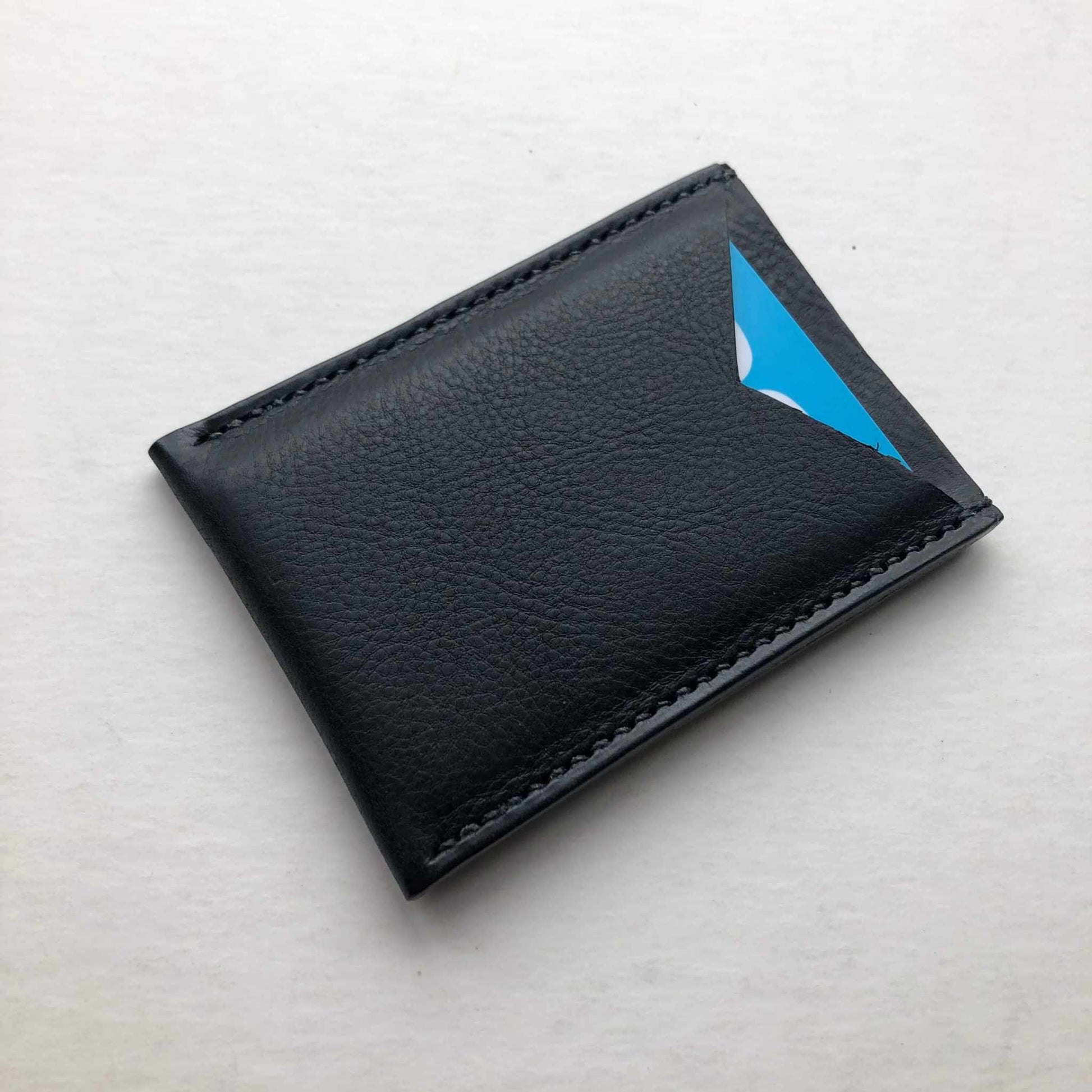 Nomad Leather Card Wallet Sleeve in black on white background.