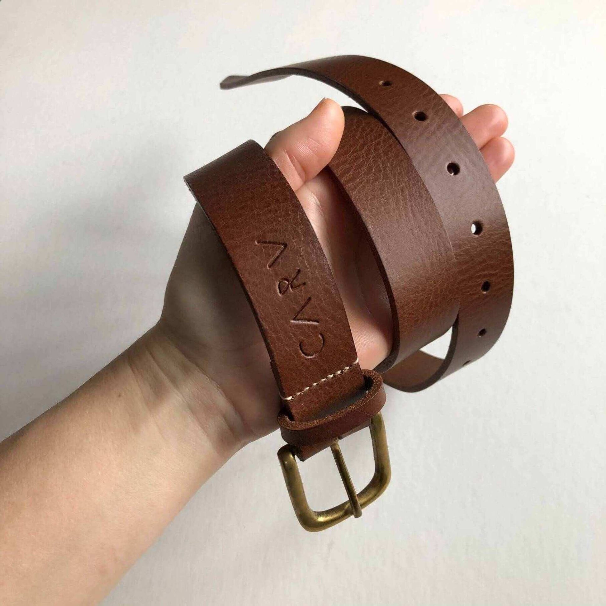 Stitched wide leather belt in tan, handcrafted with sustainable vegetable-tanned leather, featuring hand-stitched accents, available in black or tan.