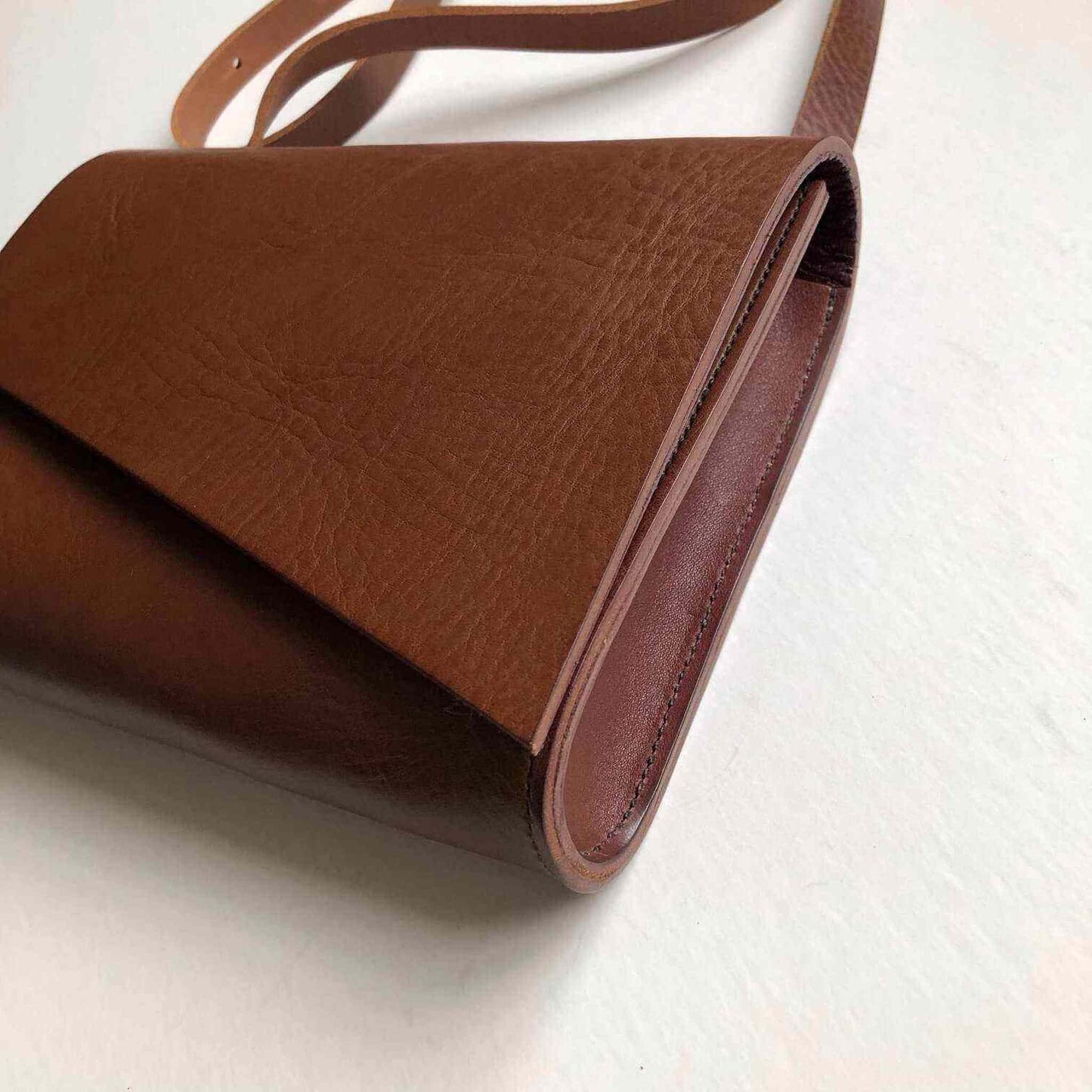 Tan Leather Crossbody Bag with asymmetrical flap and adjustable strap, handcrafted from sustainable vegetable-tanned leather.