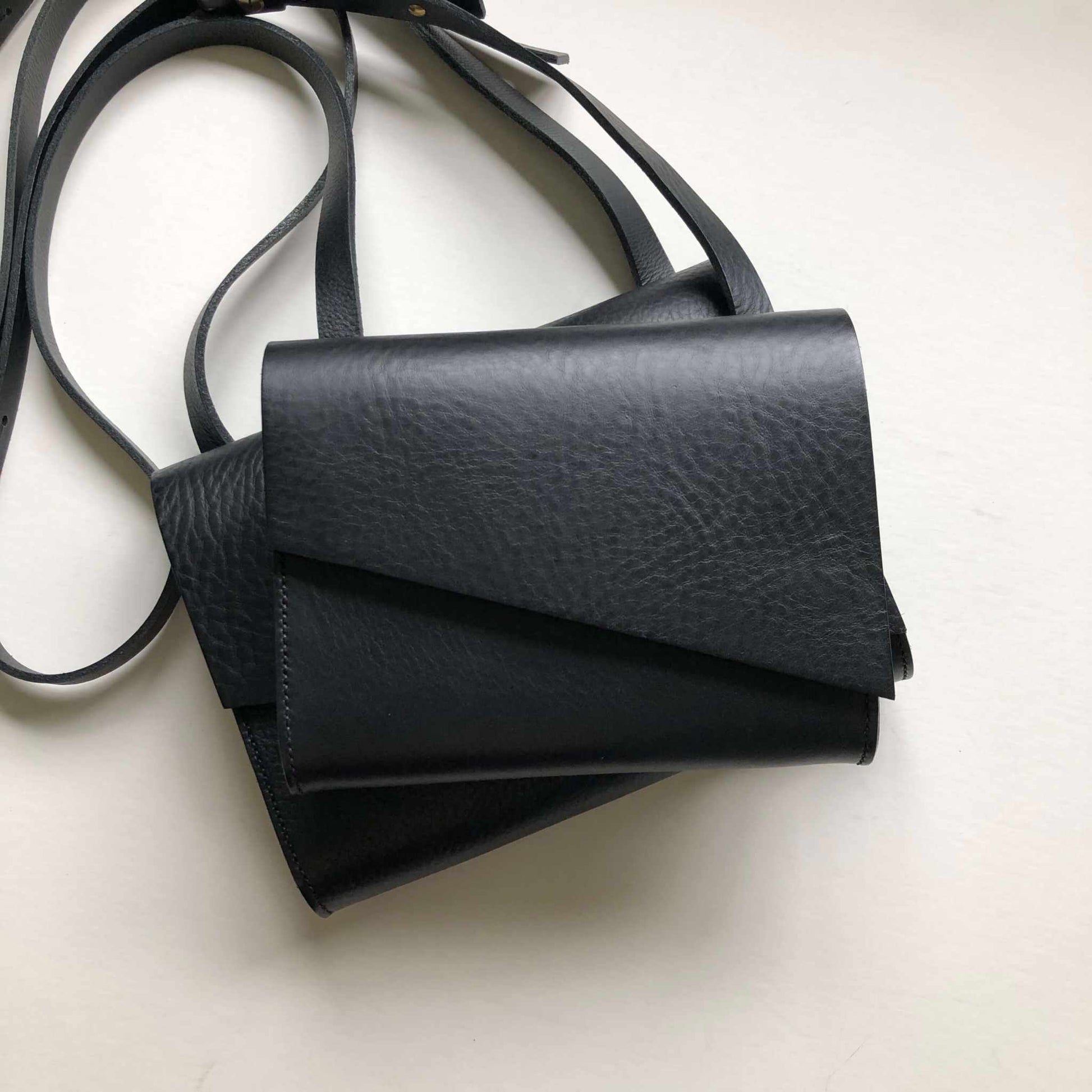 Pioneer Mini Black Leather Crossbody Bag with adjustable strap and minimalist design.