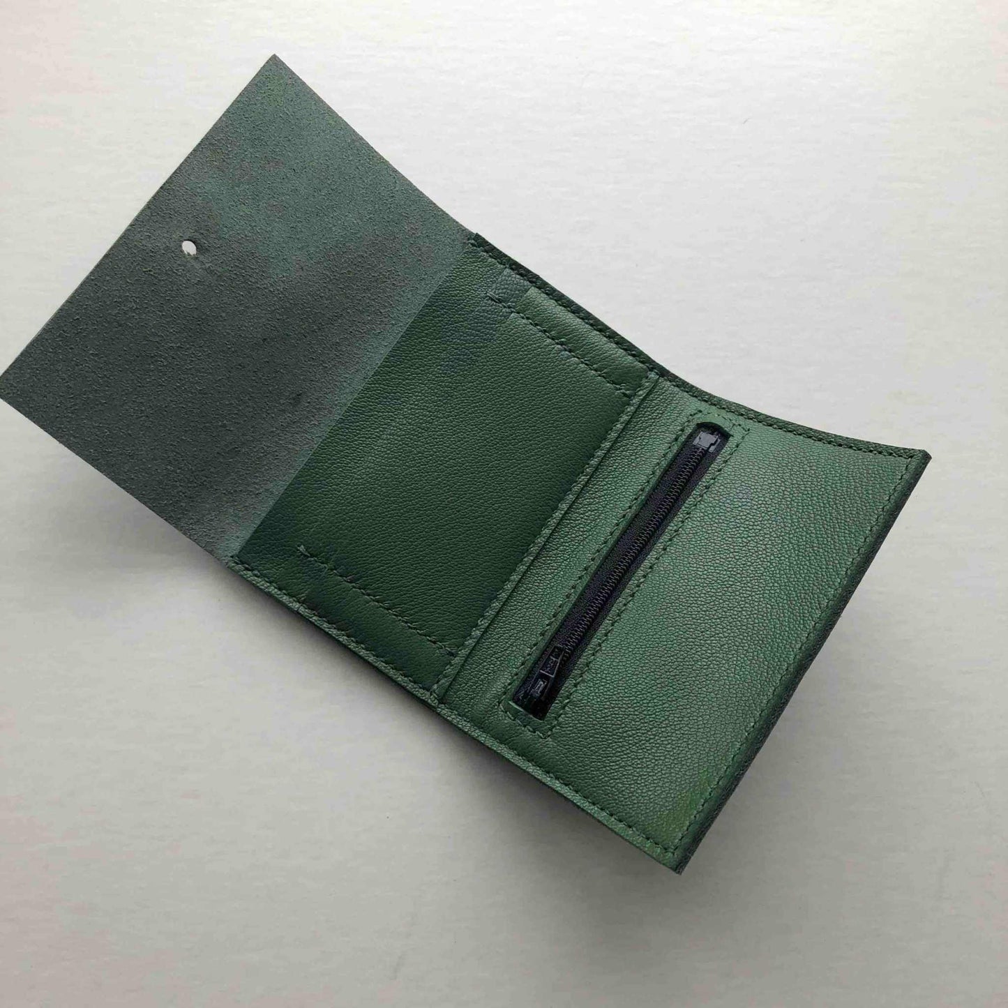 Nomad Mini Leather Women's Wallet in green, showcasing card slots and zipped coin pocket.