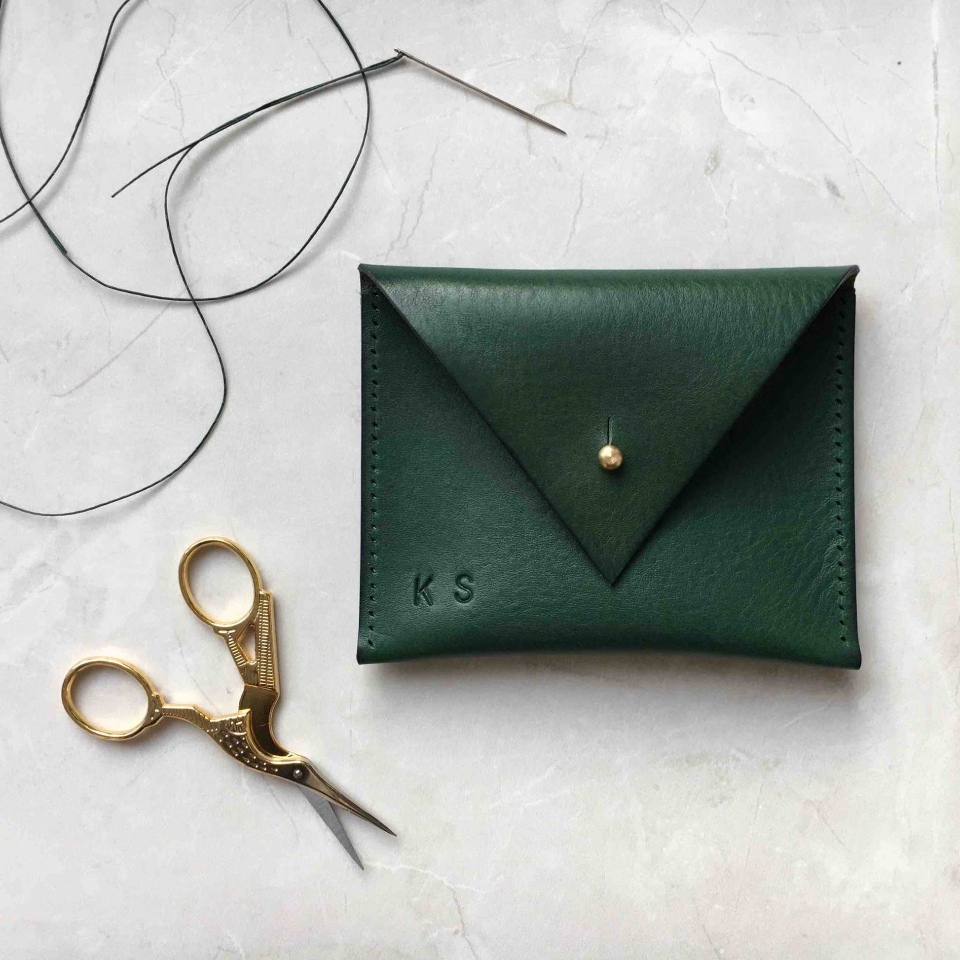 Green Drifter Mini Leather Coin Purse with triangular flap and brass press stud, handcrafted in the UK using sustainable vegetable-tanned leather.