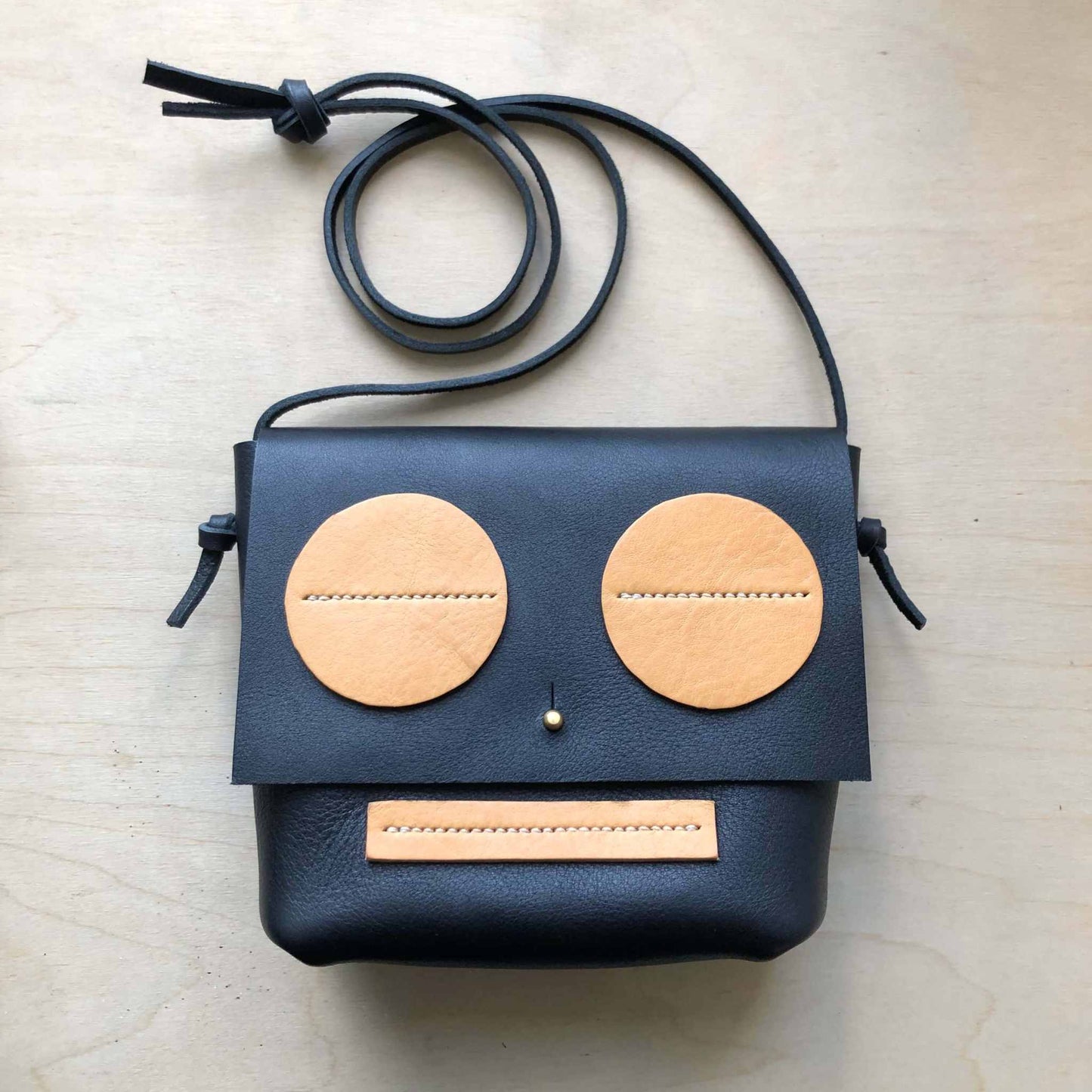 Little Robot Crossbody Bag made from black full grain leather with natural accents, handcrafted in the UK.