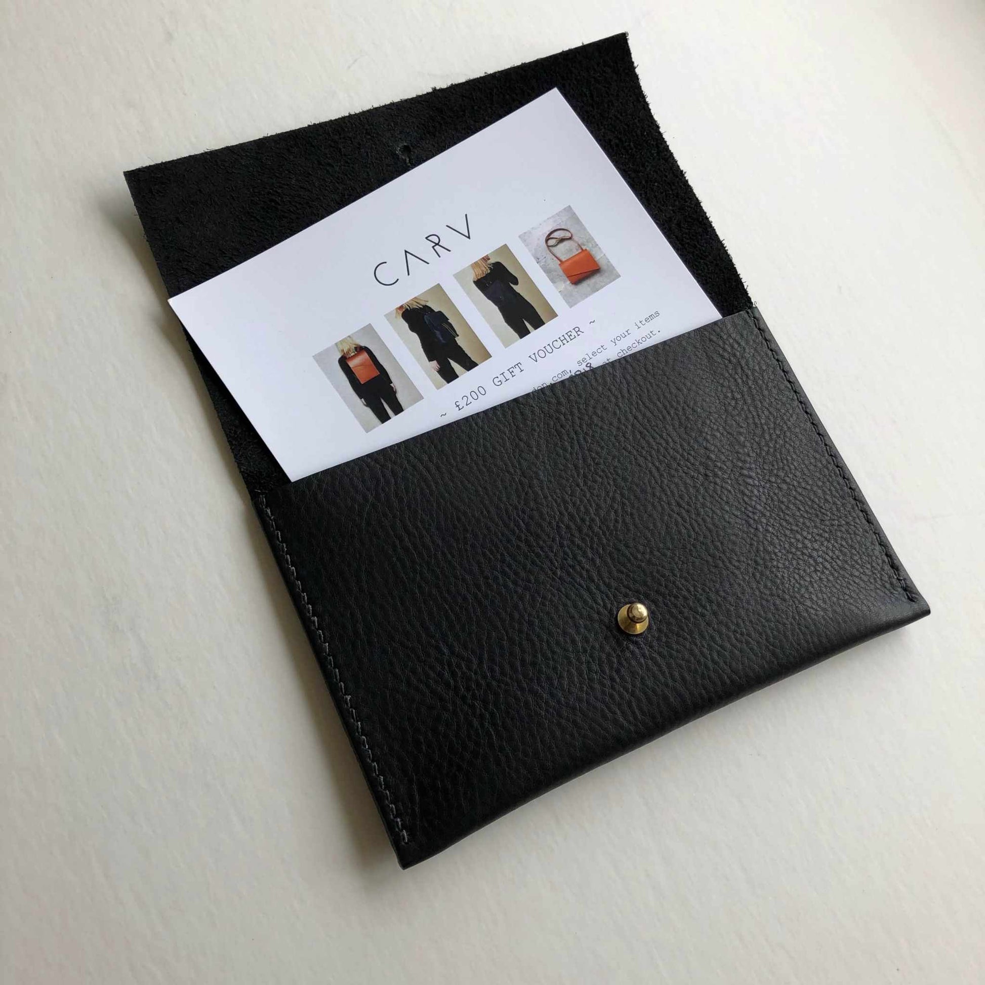 Leather gift voucher in handcrafted black leather pouch by CARV.