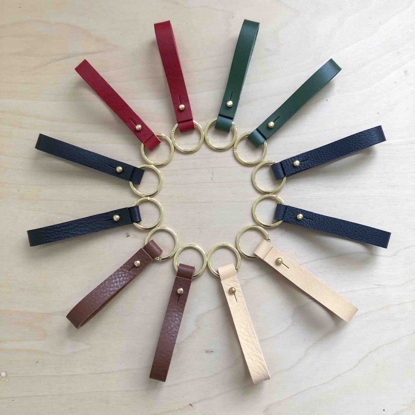 Personalised leather keyring in various colors with brass ring and press stud closure.