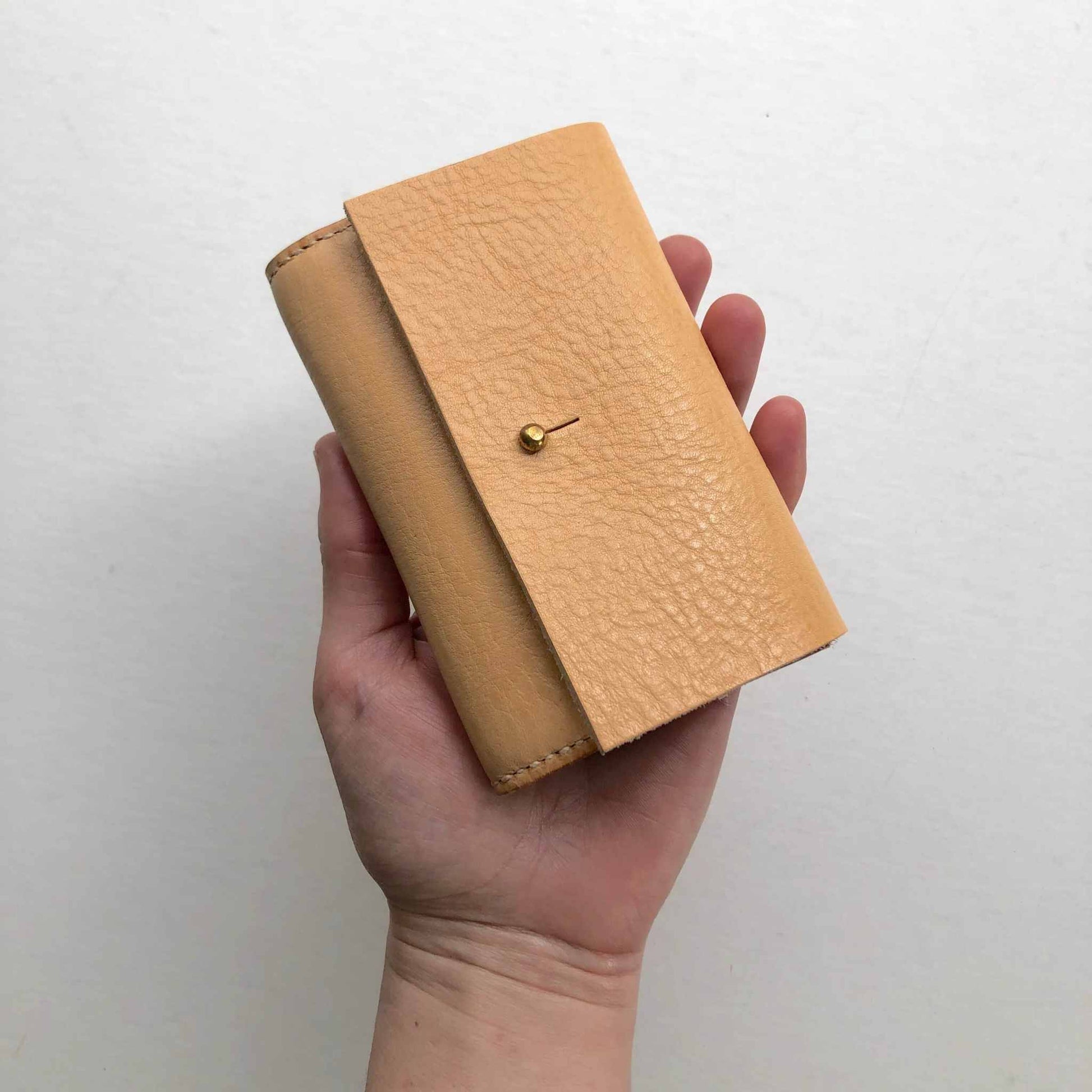 Nomad Mini Handmade Leather Wallet in nude, sustainable vegetable-tanned leather, compact, minimalist design.