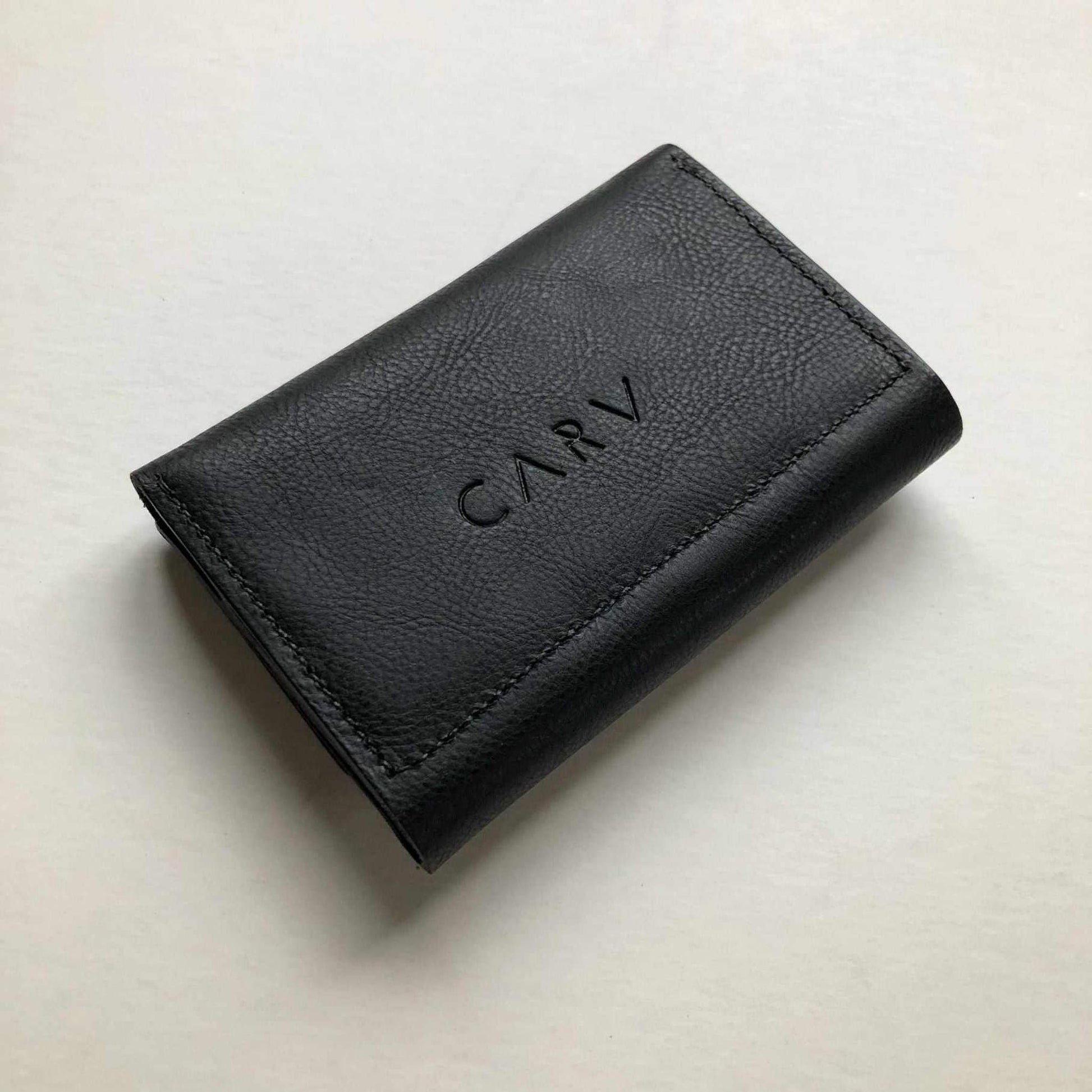 Small black leather folding wallet purse, Knot Mini, with CARV logo.