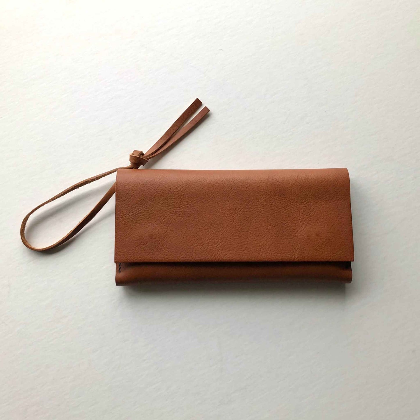 Knot Leather Purse Wallet in tan with wrist strap, handcrafted from vegetable-tanned leather.