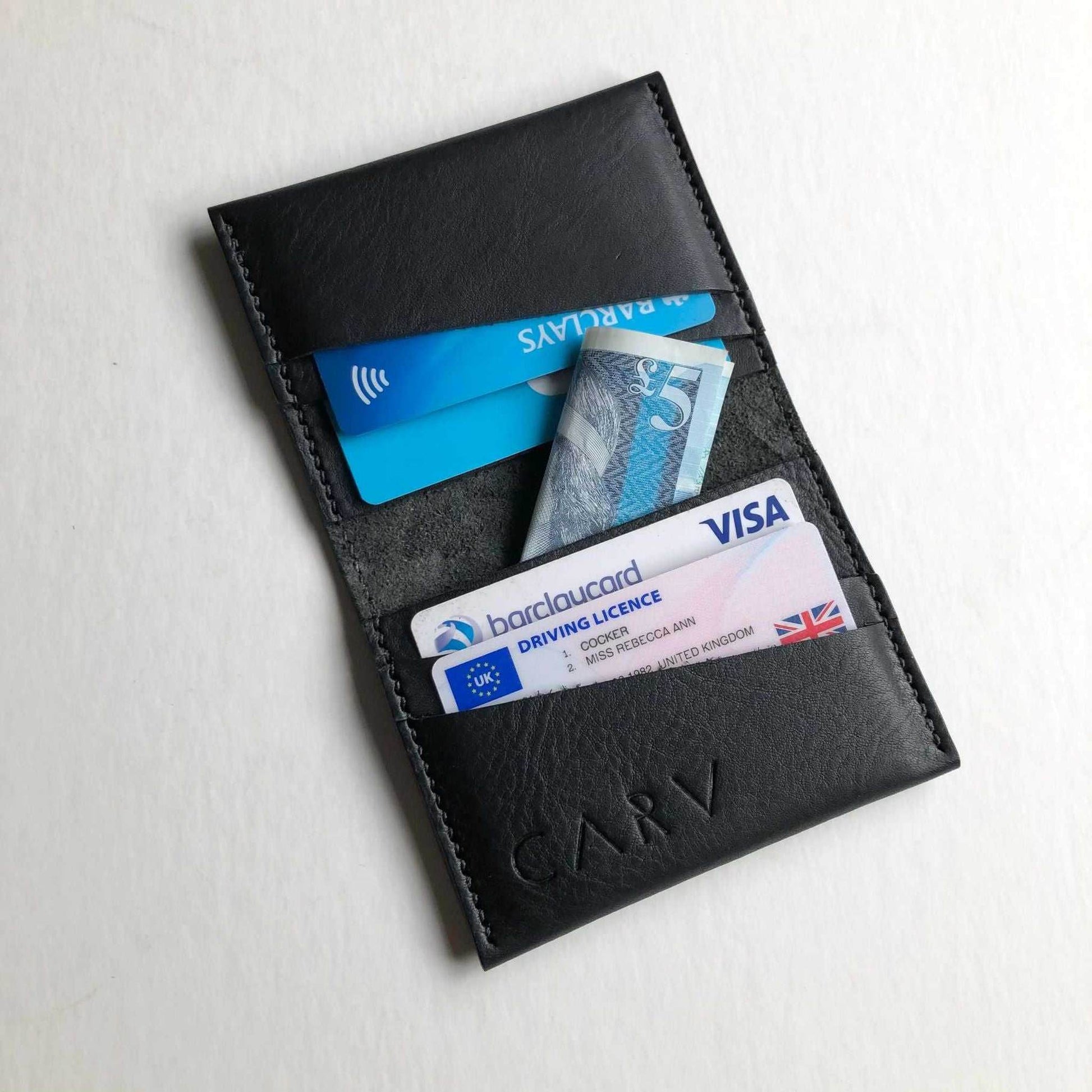 Minimalist Fold Leather Bifold Card Wallet by CARV in black with card slots and folded banknotes, handcrafted in Devon.