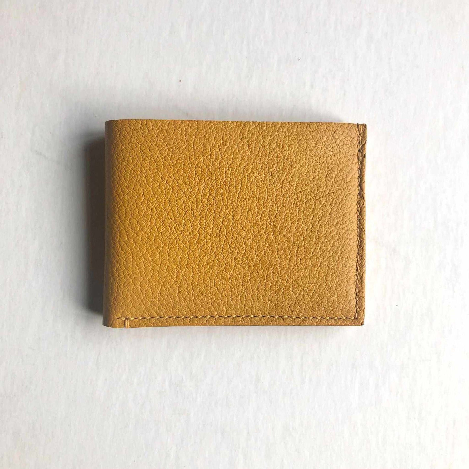 Mustard yellow handmade leather wallet, minimalist design, UK craftsmanship.