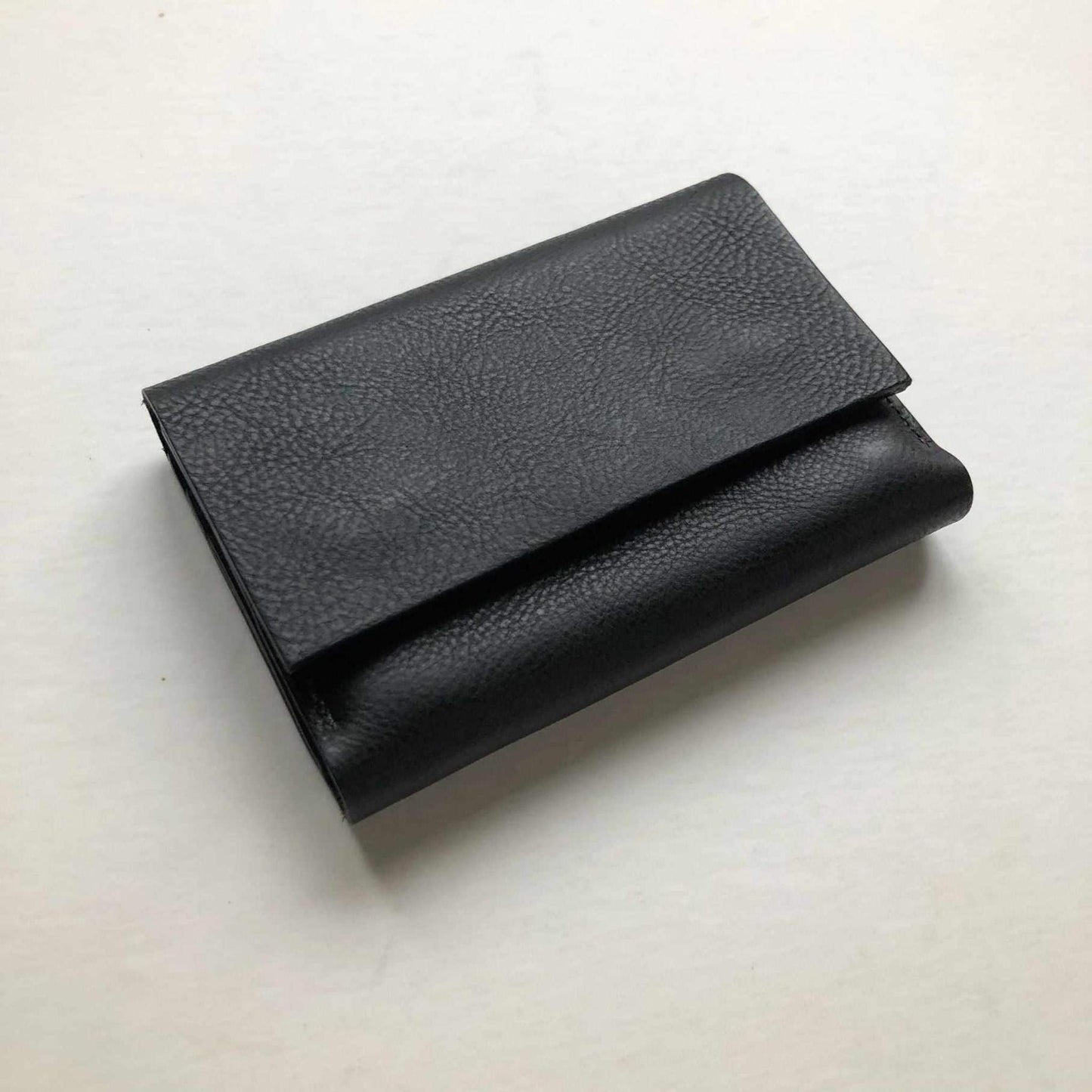 Small leather folding wallet purse Knot Mini; black pebble grain leather; handcrafted; minimalist design.