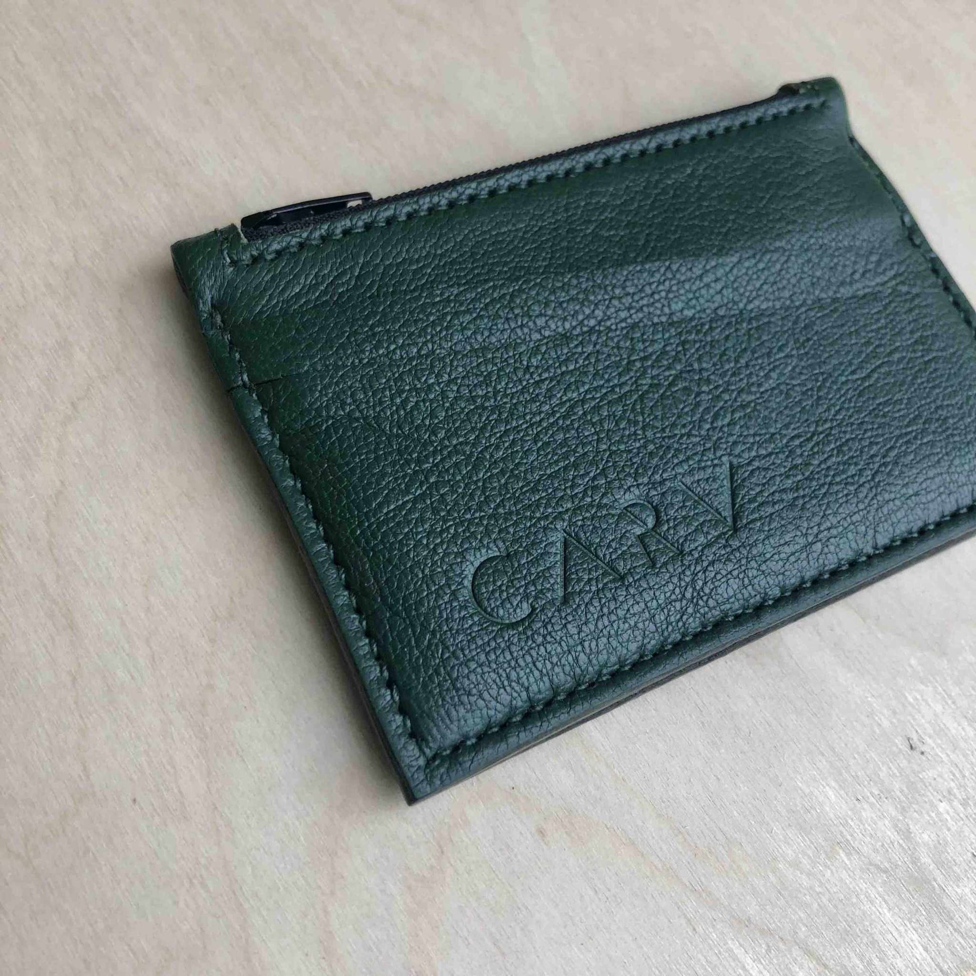 Green Zipped Leather Card Holder by CARV with minimalist design and zipper pocket.