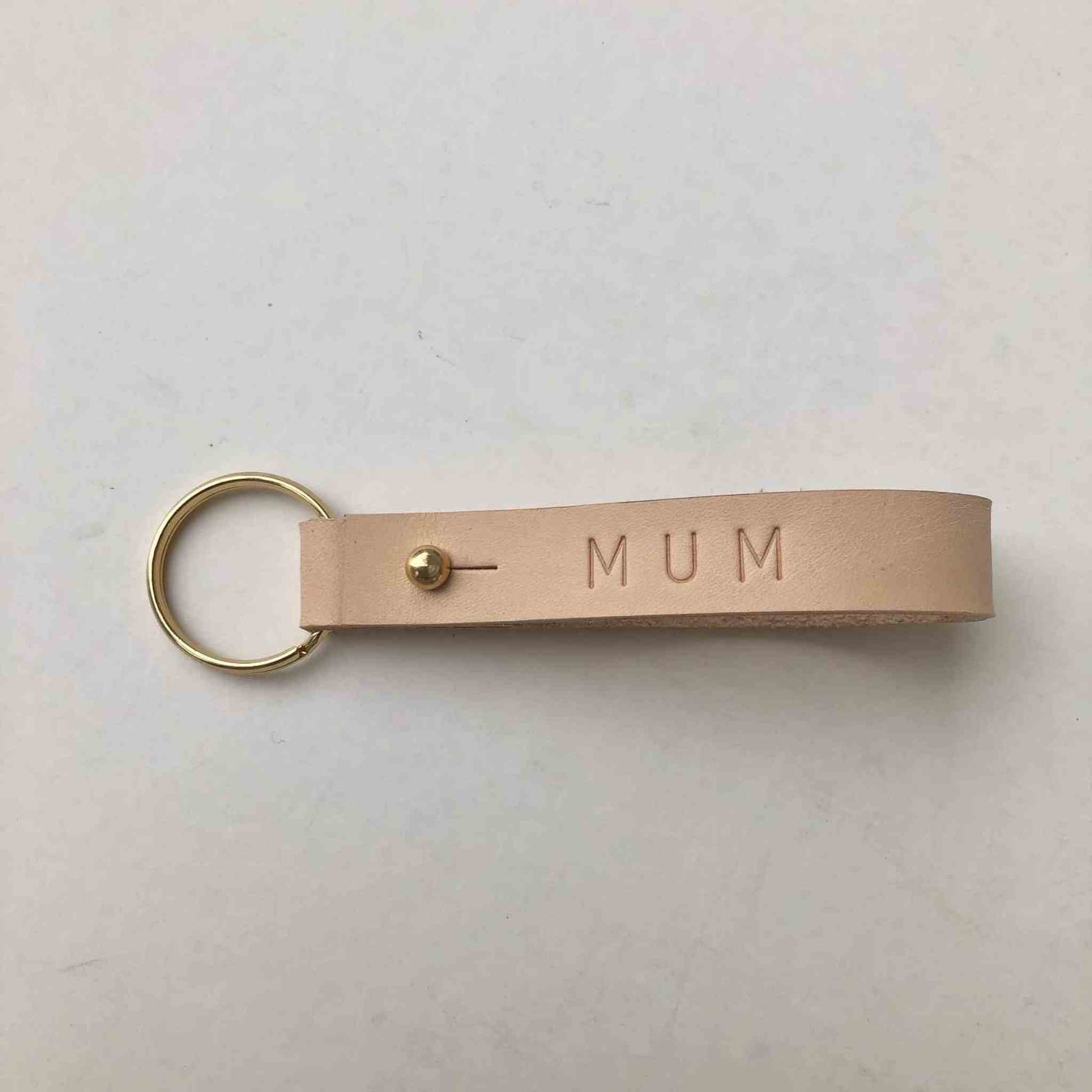 Nomad Personalised Leather Keyring in natural color with "MUM" embossed, featuring brass press stud closure.