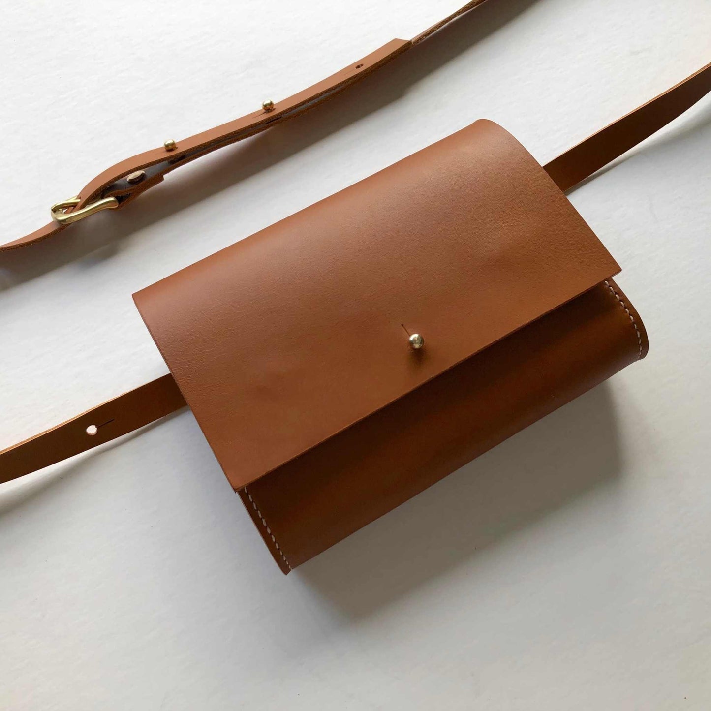 Sedna Tan Leather Belt Bag by CARV, handcrafted in the UK, minimalist design with adjustable strap, sustainably sourced vegetable-tanned leather.