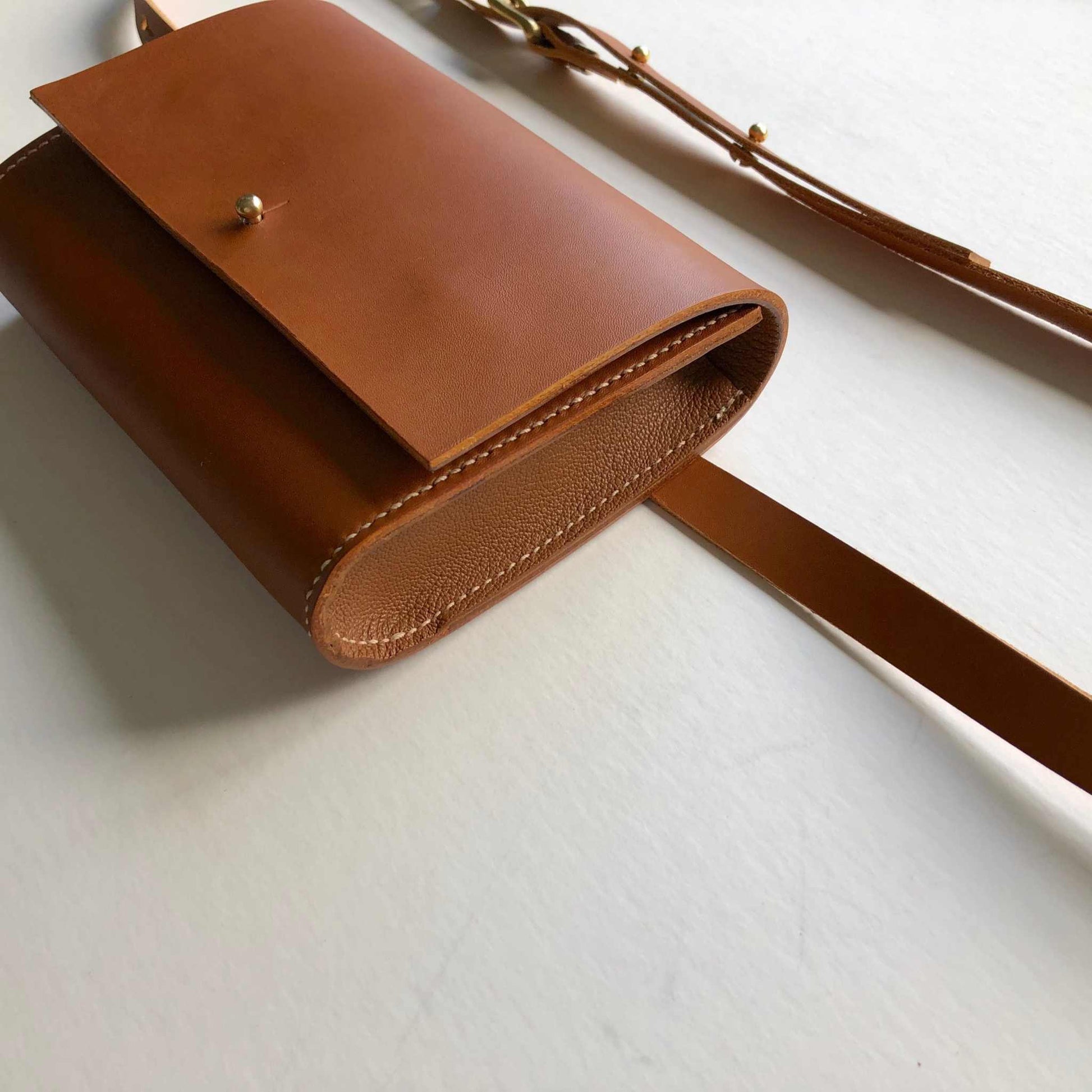 Tan leather belt bag with a minimalist design, handcrafted in the UK from sustainably sourced vegetable-tanned leather.