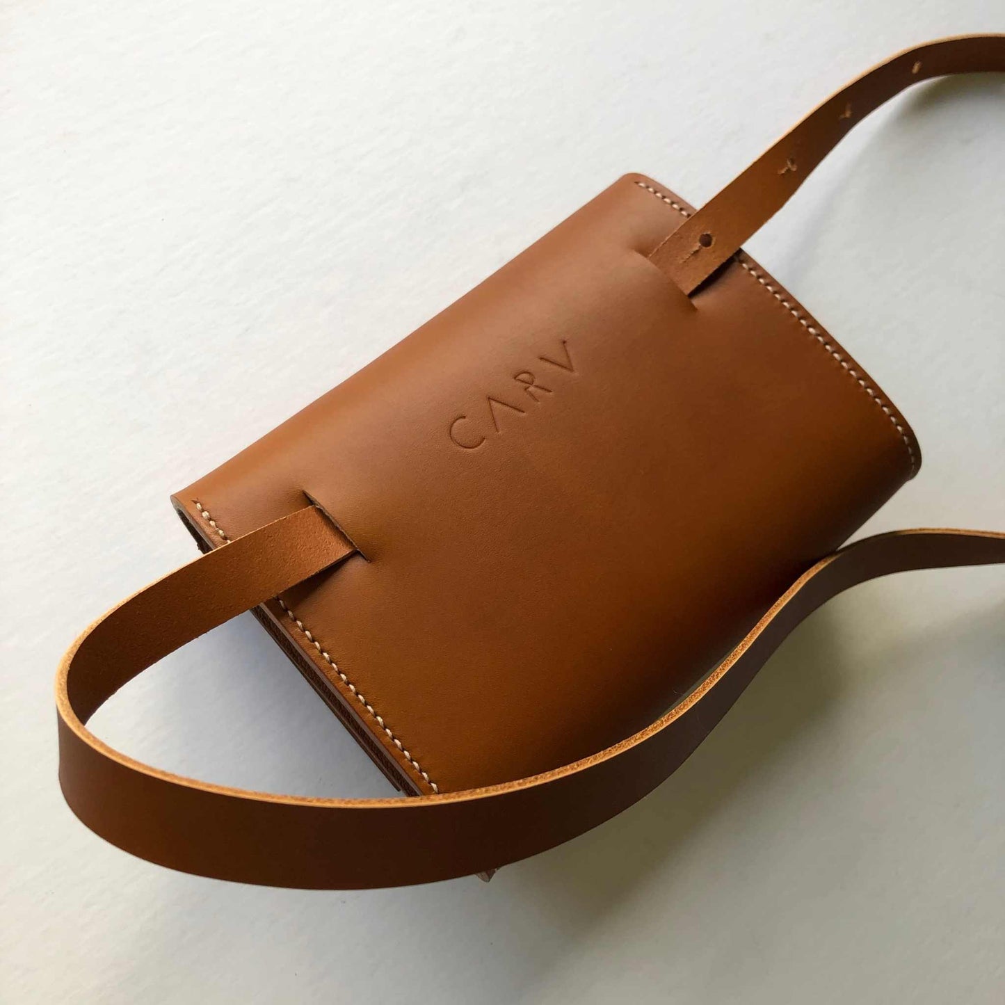 Tan leather belt bag by CARV, minimalist design, sustainably sourced, handcrafted in the UK.