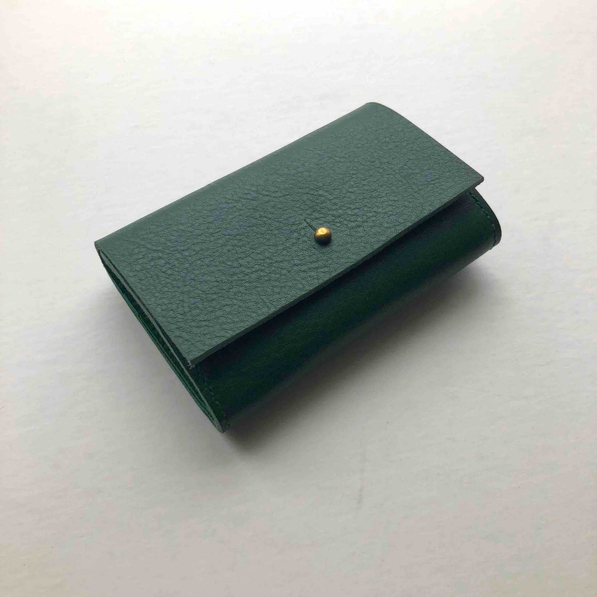 Green Nomad Mini Leather Women's Wallet with brass closure, handcrafted from sustainable leather.