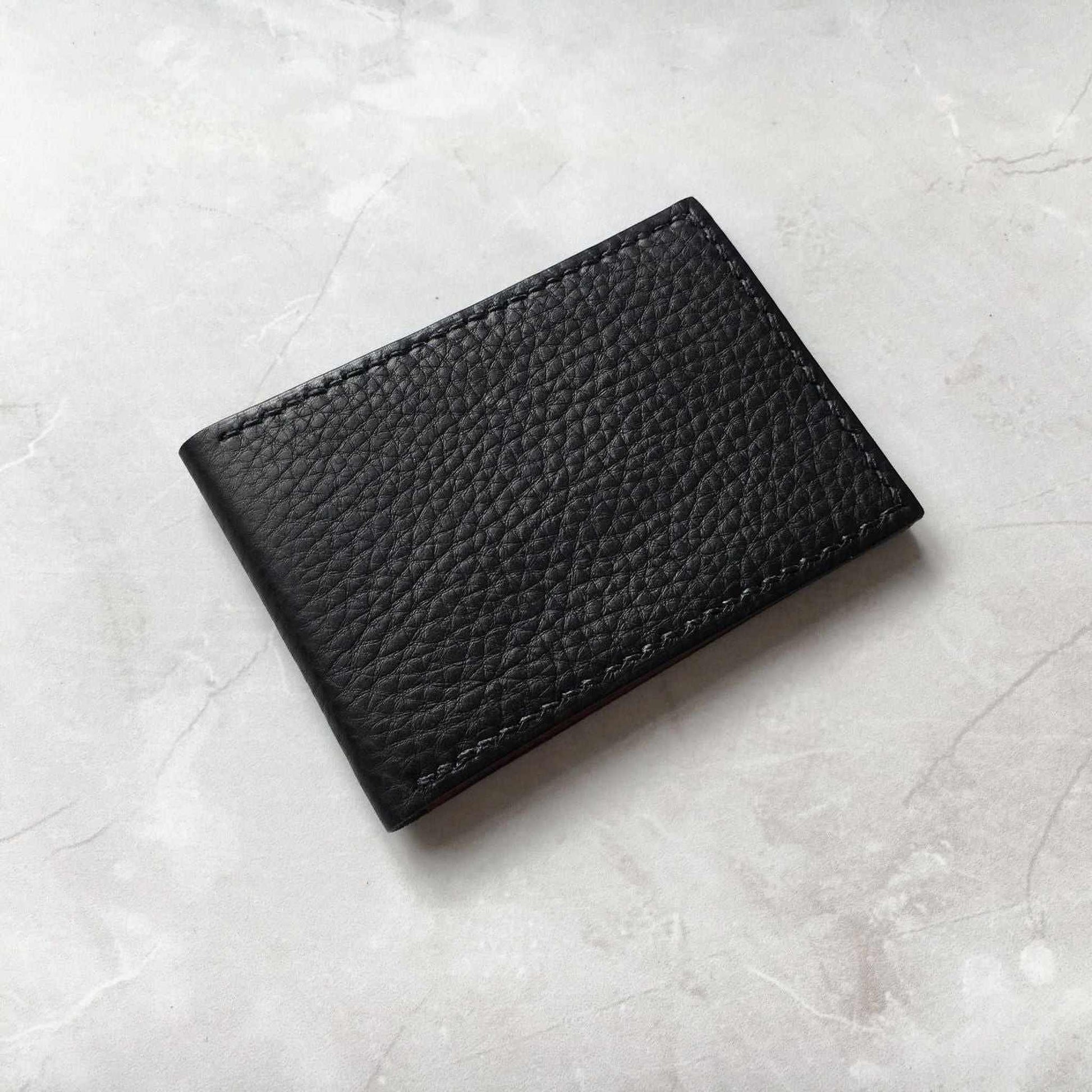 Nomad Leather Bifold Card Wallet in black raised grain leather, handmade in Devon, UK.