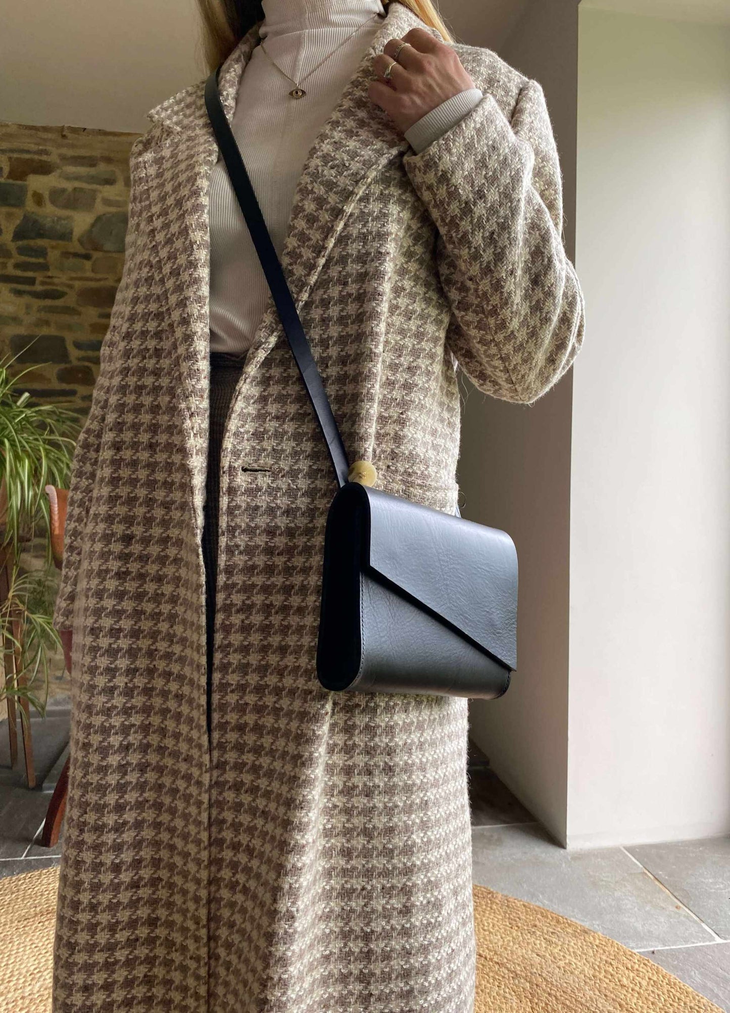 Pioneer Mini Black Leather Crossbody Bag worn with houndstooth coat.