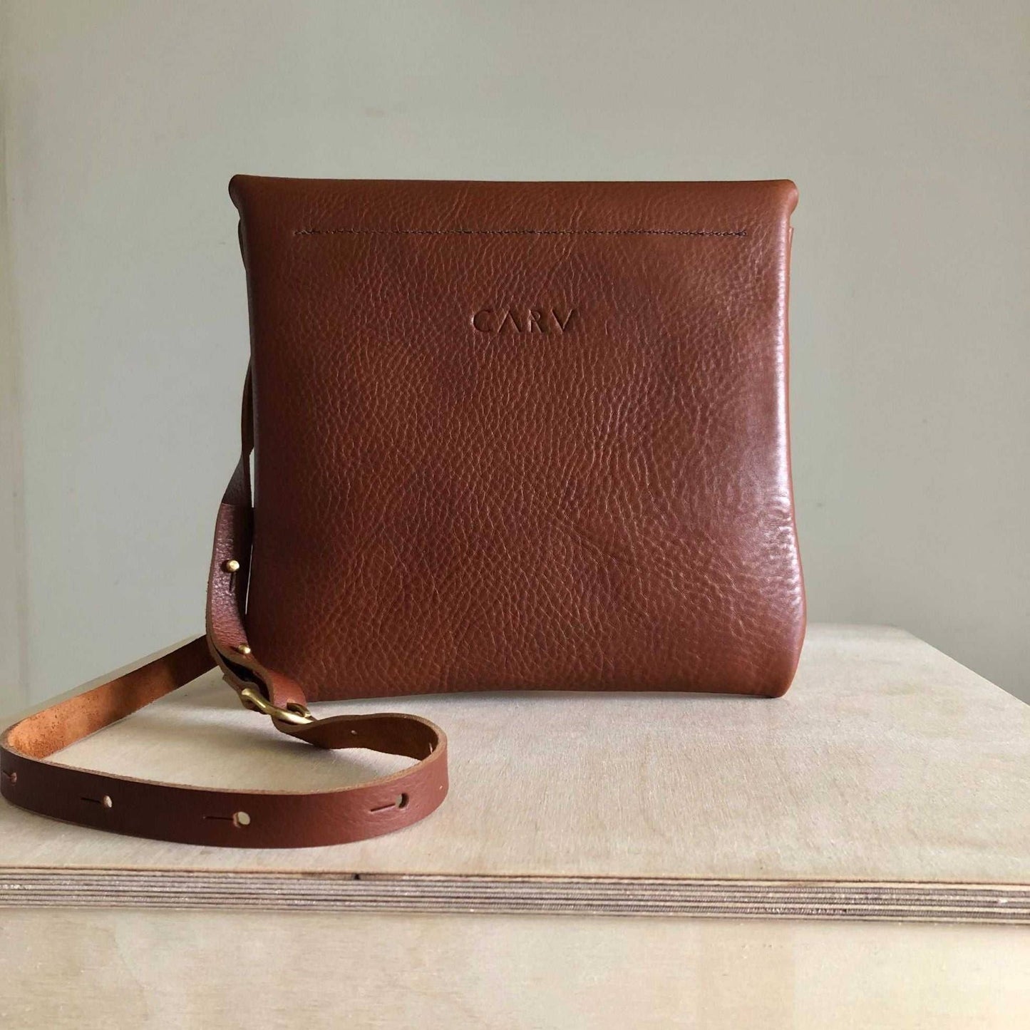 Drifter Leather Crossbody Bag in tan, handcrafted with sustainable leather, minimalist design.