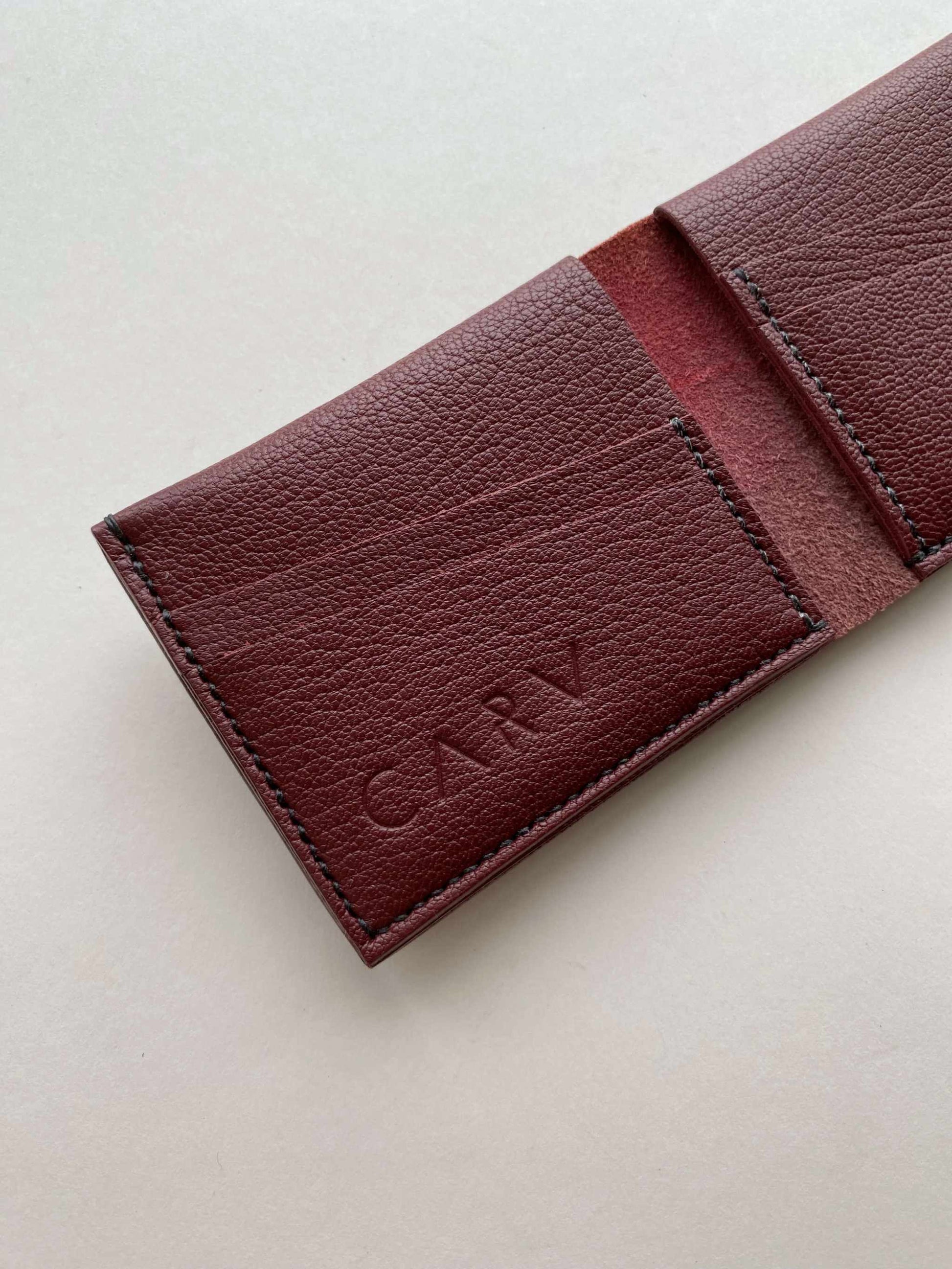 Handmade leather wallet in burgundy with card slots.