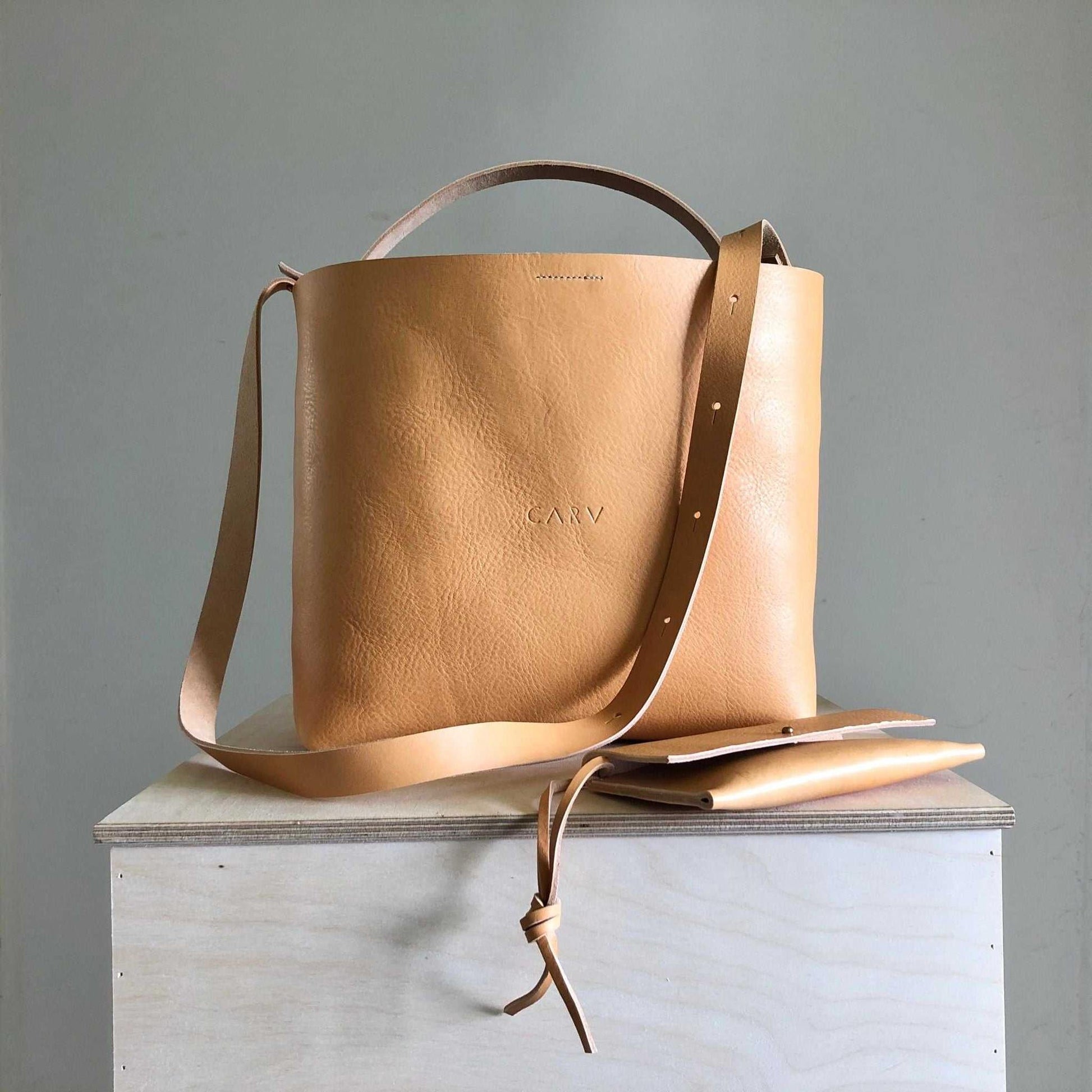 Basket Midi Leather Tote Bag in natural vegetable-tanned leather with detachable straps, showcasing minimalist design and British craftsmanship.