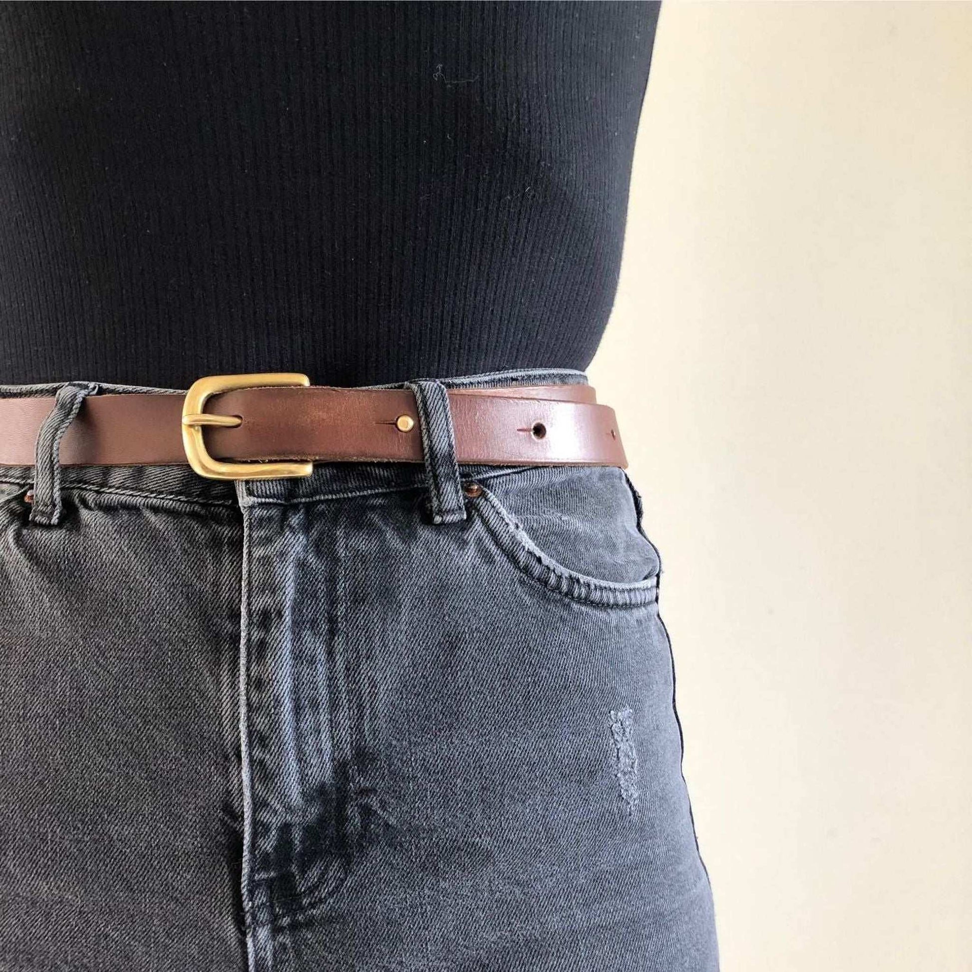 Nomad Midi Width Black Leather Belt on jeans, handcrafted sustainable design, solid brass stud, UK-made.