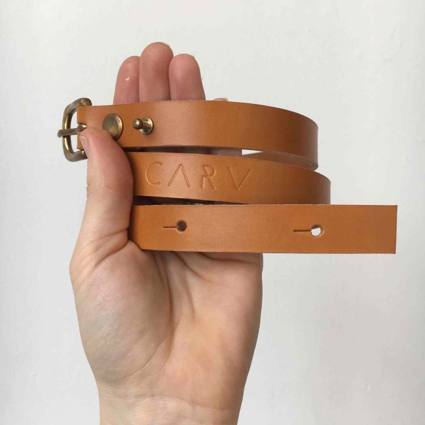 Handmade tan leather belt with narrow width and brass buckle by CARV.